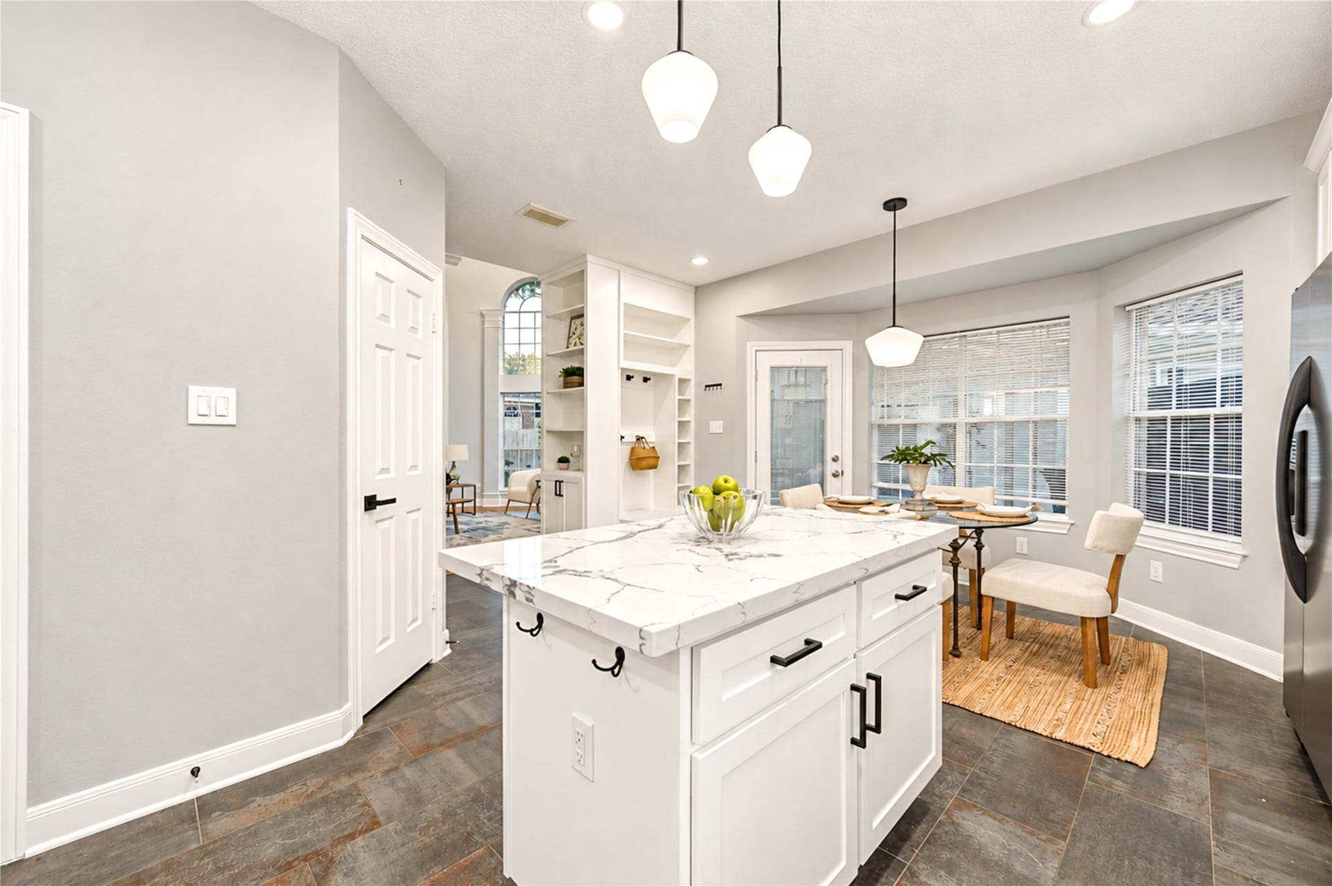 14215 Edinburgh Court, Houston, TX 77077 From morning coffee to casual dinners, this thoughtfully designed kitchen and breakfast area make everyday living a delight! The spacious island provides the perfect gathering spot, while the open layout creates an effortless connection between cooking, dining and spending time together.