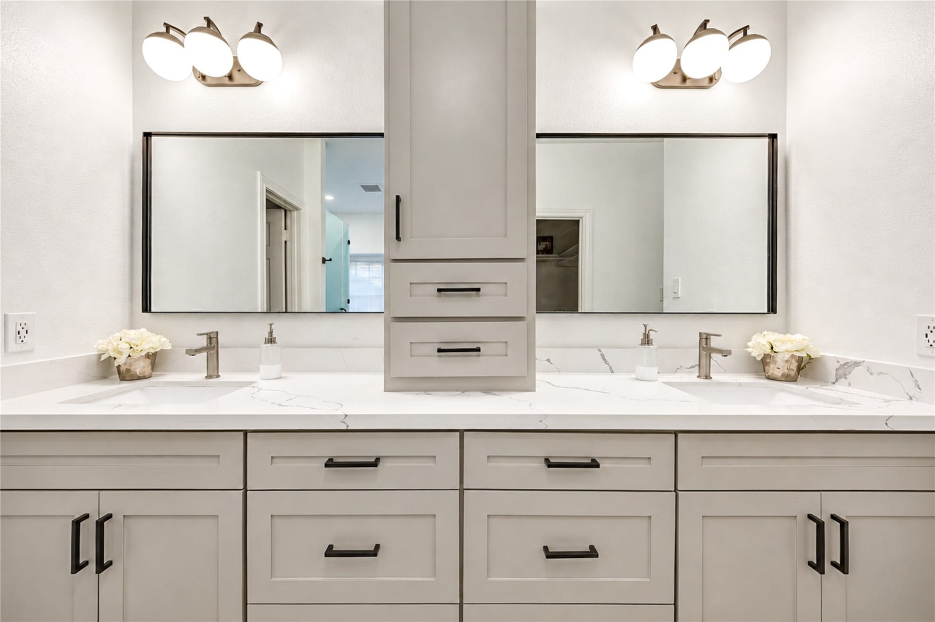14215 Edinburgh Court, Houston, TX 77077 A little luxury makes every day better! This beautifully renovated primary bath features separate vanities with quartz countertops, stylish mirrors and elegant finishes, giving everyone their own space to get ready in the morning or unwind at the end of the day. Thoughtfully designed for comfort, convenience and effortless style!