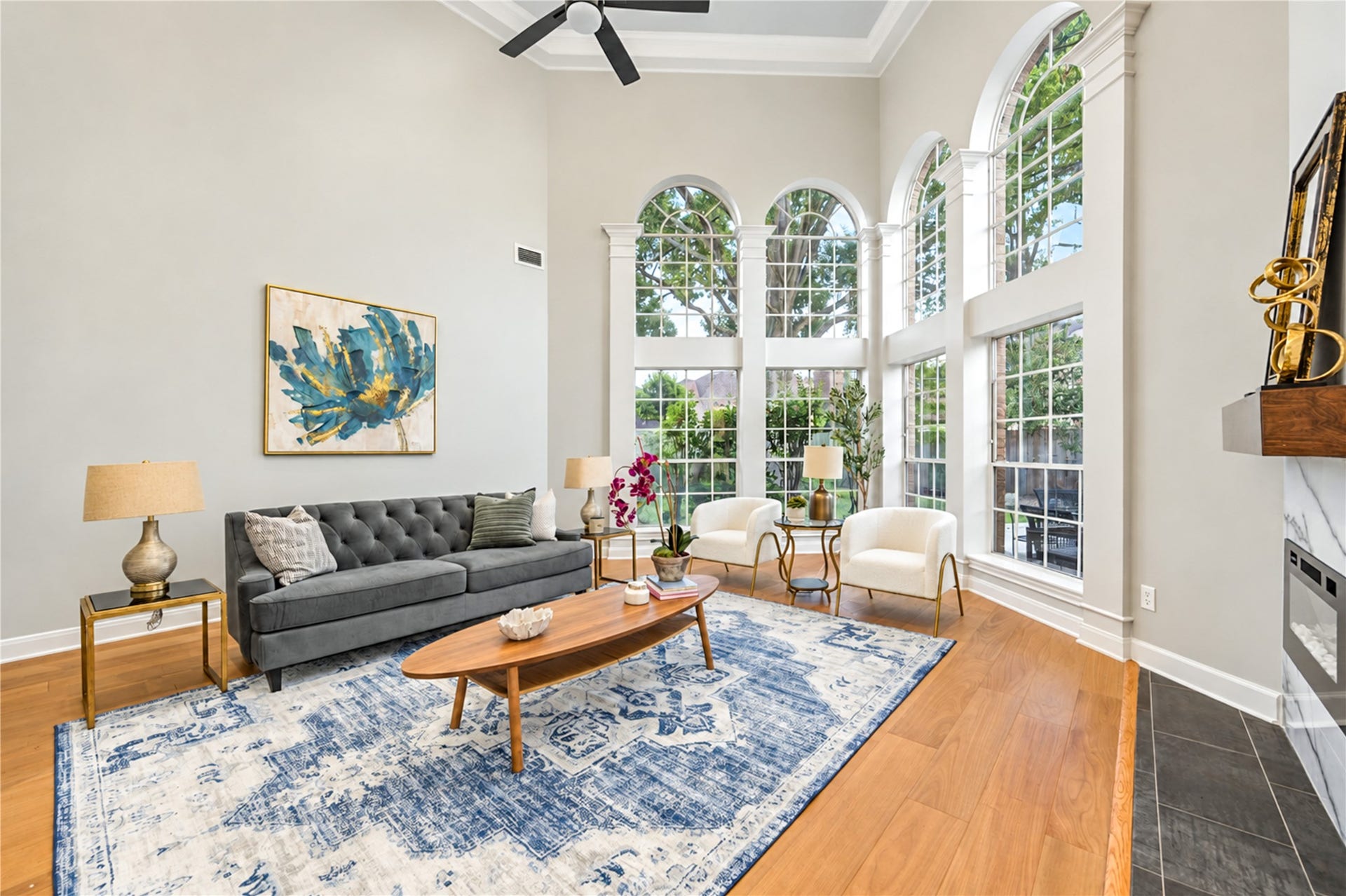 14215 Edinburgh Court, Houston, TX 77077 Bathed in natural light from dramatic two-story windows, this beautiful family room invites you to slow down and enjoy life's everyday moments. From cozy evenings by the fireplace to lively gatherings with friends, soaring ceilings and picturesque backyard views create a warm, welcoming space you'll love coming home to!