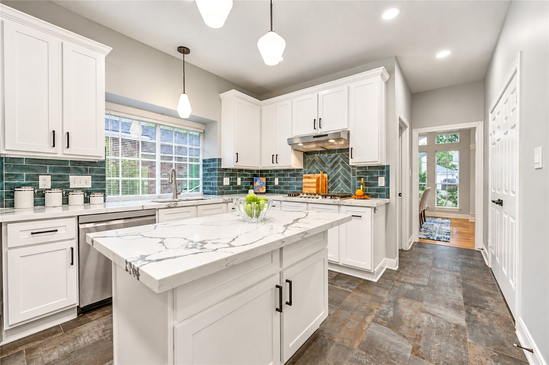 14215 Edinburgh Court, Houston, TX 77077 A kitchen designed for the way you live! The spacious center island invites everything from casual morning breakfasts to lively conversations while dinner is being prepared. Beautiful quartz countertops, crisp white cabinetry and modern finishes create a bright, welcoming space that makes cooking and entertaining a pleasure!