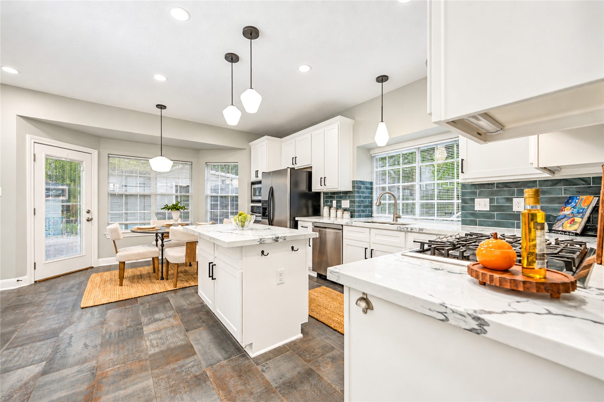 14215 Edinburgh Court, Houston, TX 77077 Designed for effortless everyday living and entertaining! This beautifully renovated kitchen opens to a light-filled breakfast area, creating a welcoming space to enjoy morning coffee, casual meals and lively conversations. With its spacious island, modern finishes and easy flow, it's a place where everyone will love to gather!