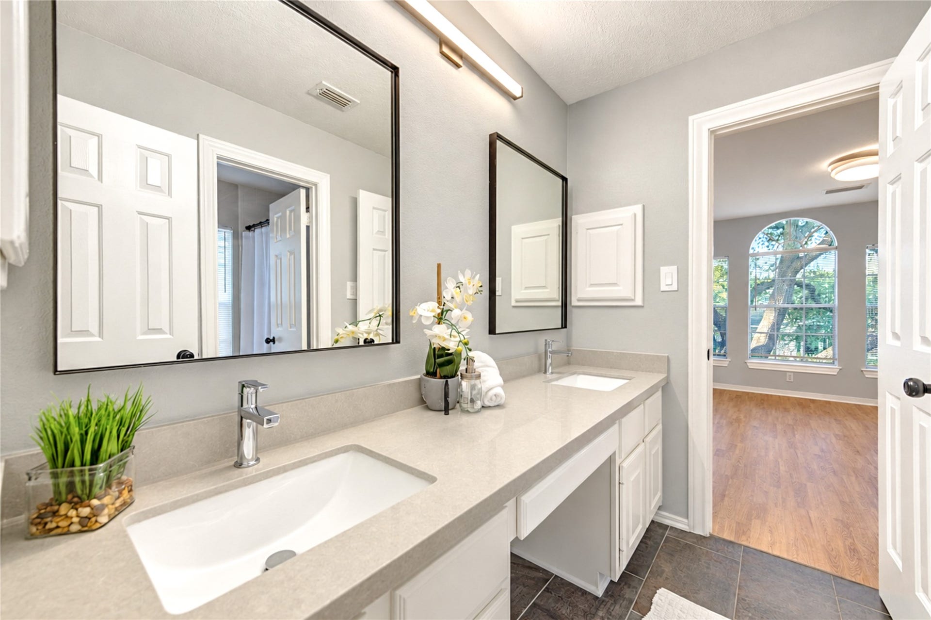 14215 Edinburgh Court, Houston, TX 77077 Style meets everyday convenience in this beautifully renovated Hollywood bathroom! Connecting two upstairs bedrooms, the spacious dual-sink vanity with elegant quartz countertops makes busy mornings effortless, while sleek fixtures and fresh, modern finishes create a bright, inviting space designed for comfort and functionality.