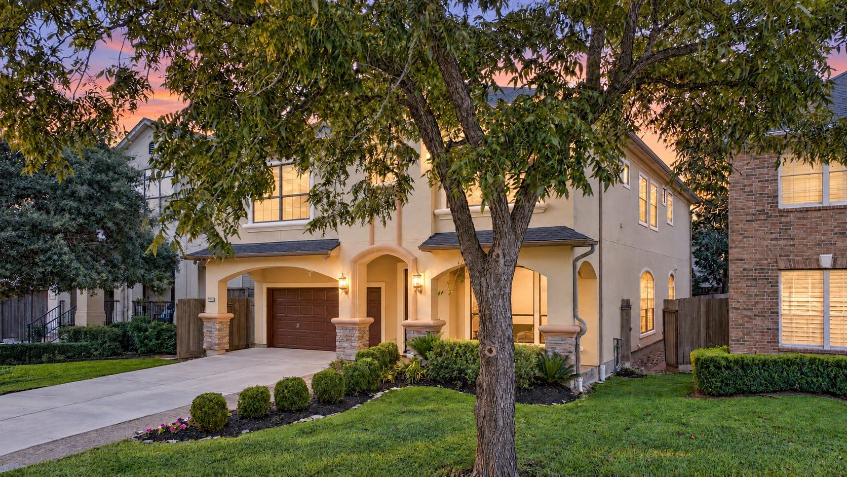 4420 Darsey Street, Bellaire, TX 77401 This twilight view highlights the front elevation, mature trees and warmly illuminated entry.