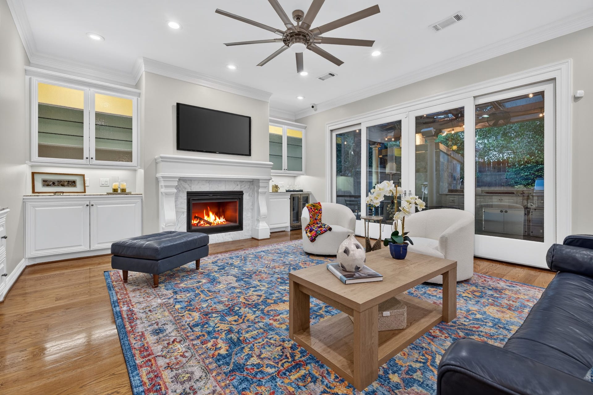 4420 Darsey Street, Bellaire, TX 77401 The main family room features a fireplace, built-in cabinetry and expansive windows overlooking the backyard.