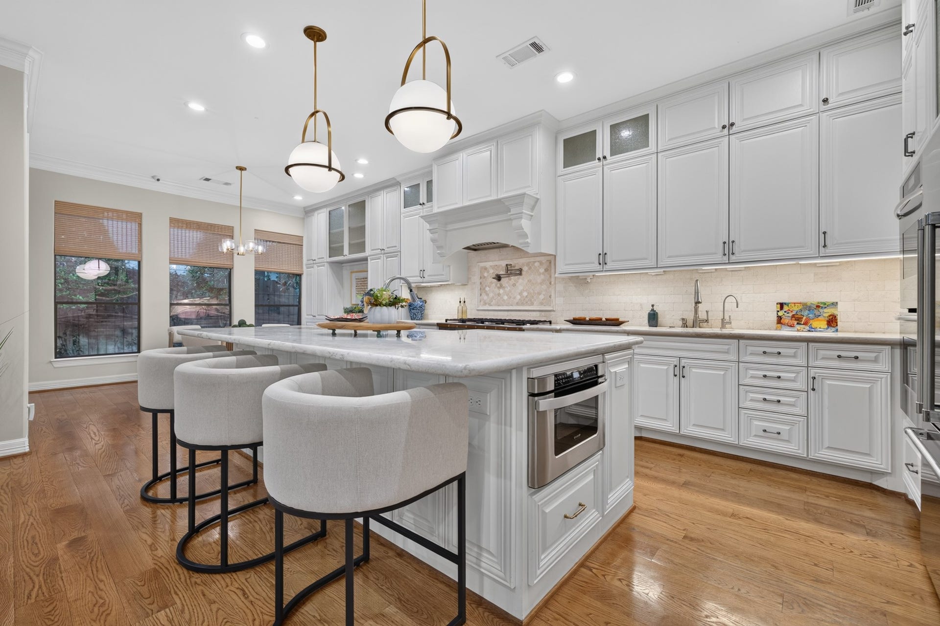 4420 Darsey Street, Bellaire, TX 77401 Updated pendant lighting adds a fresh finishing touch above the kitchen island and its casual seating area.