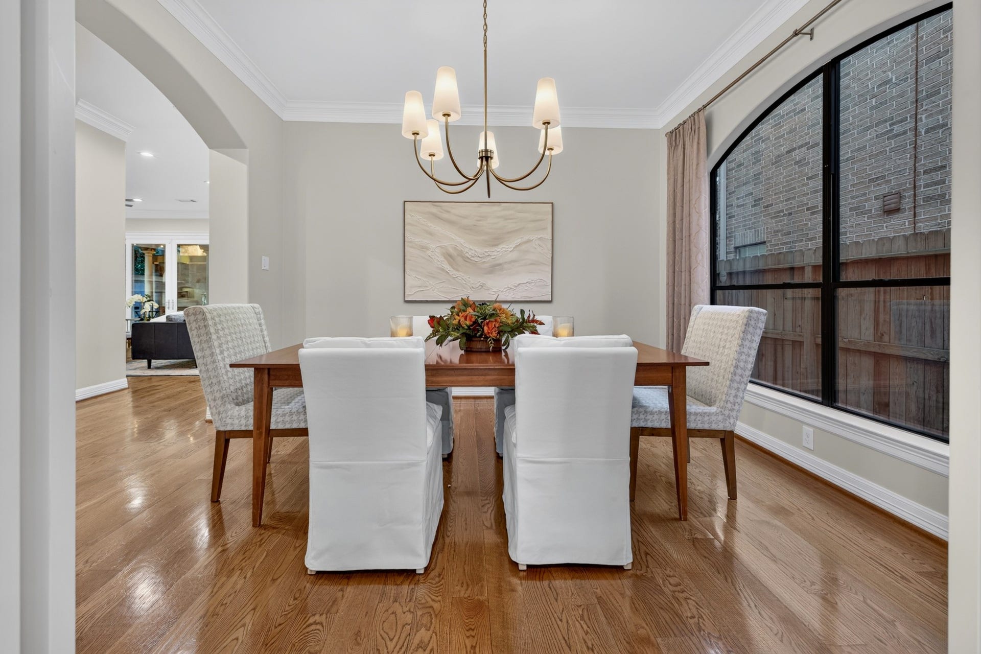 4420 Darsey Street, Bellaire, TX 77401 Large windows, wood flooring and an elegant chandelier give the formal dining room a warm, welcoming feel.