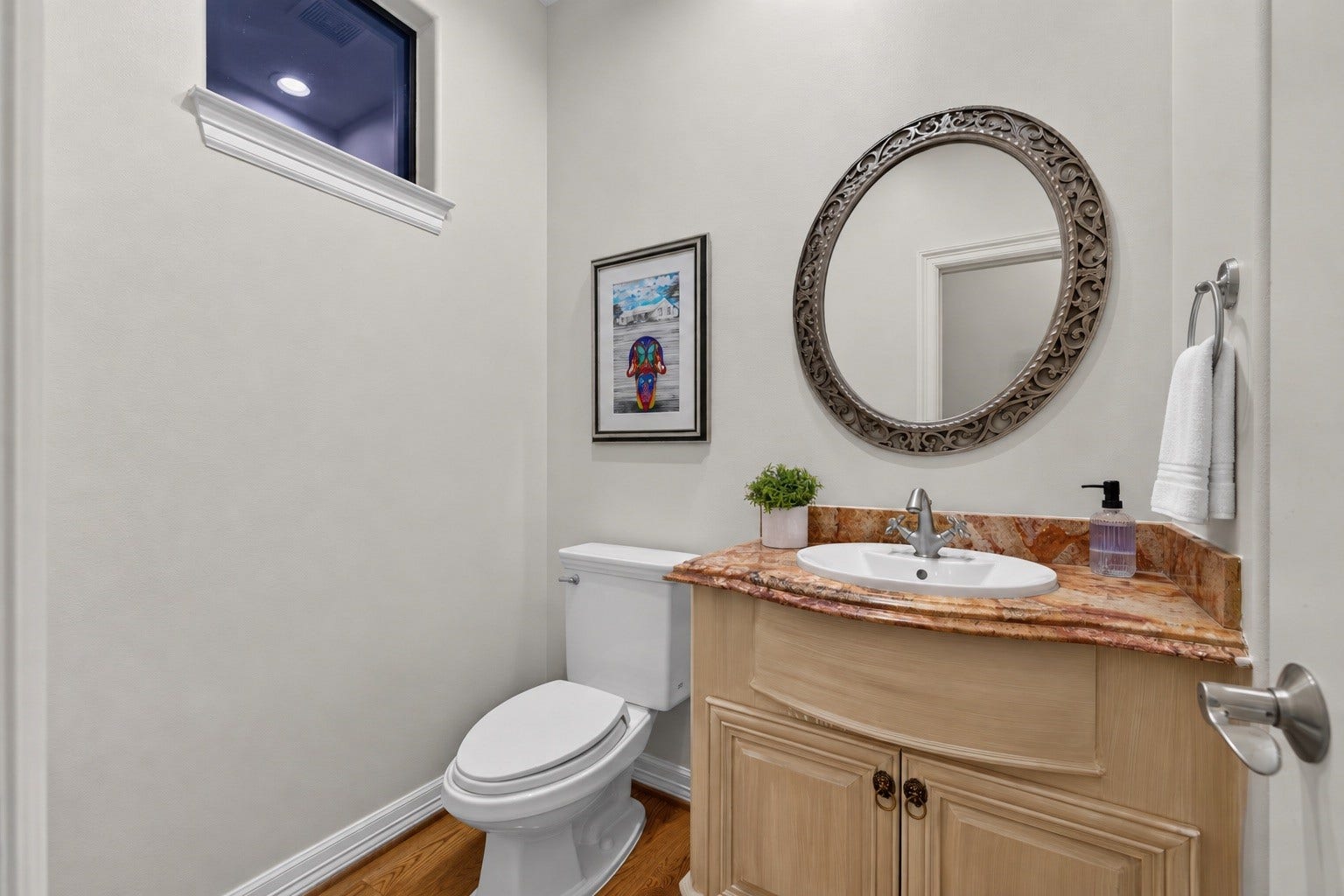 4420 Darsey Street, Bellaire, TX 77401 The powder bath features a wood vanity and vessel sink, providing a convenient space for guests.
