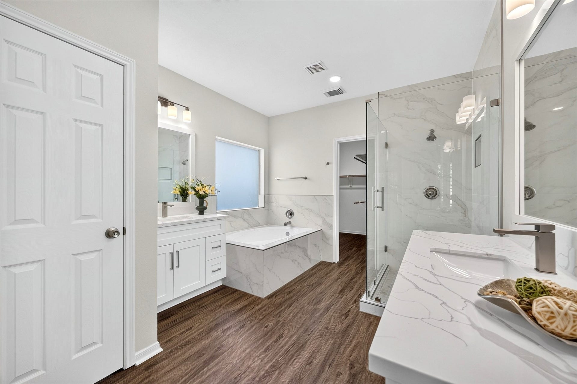 3114 Brannon Hill Lane, Sugar Land, TX 77479 Elegant bathroom featuring a luxurious soaking tub, spacious glass-enclosed shower, and dual vanities with sleek marble countertops