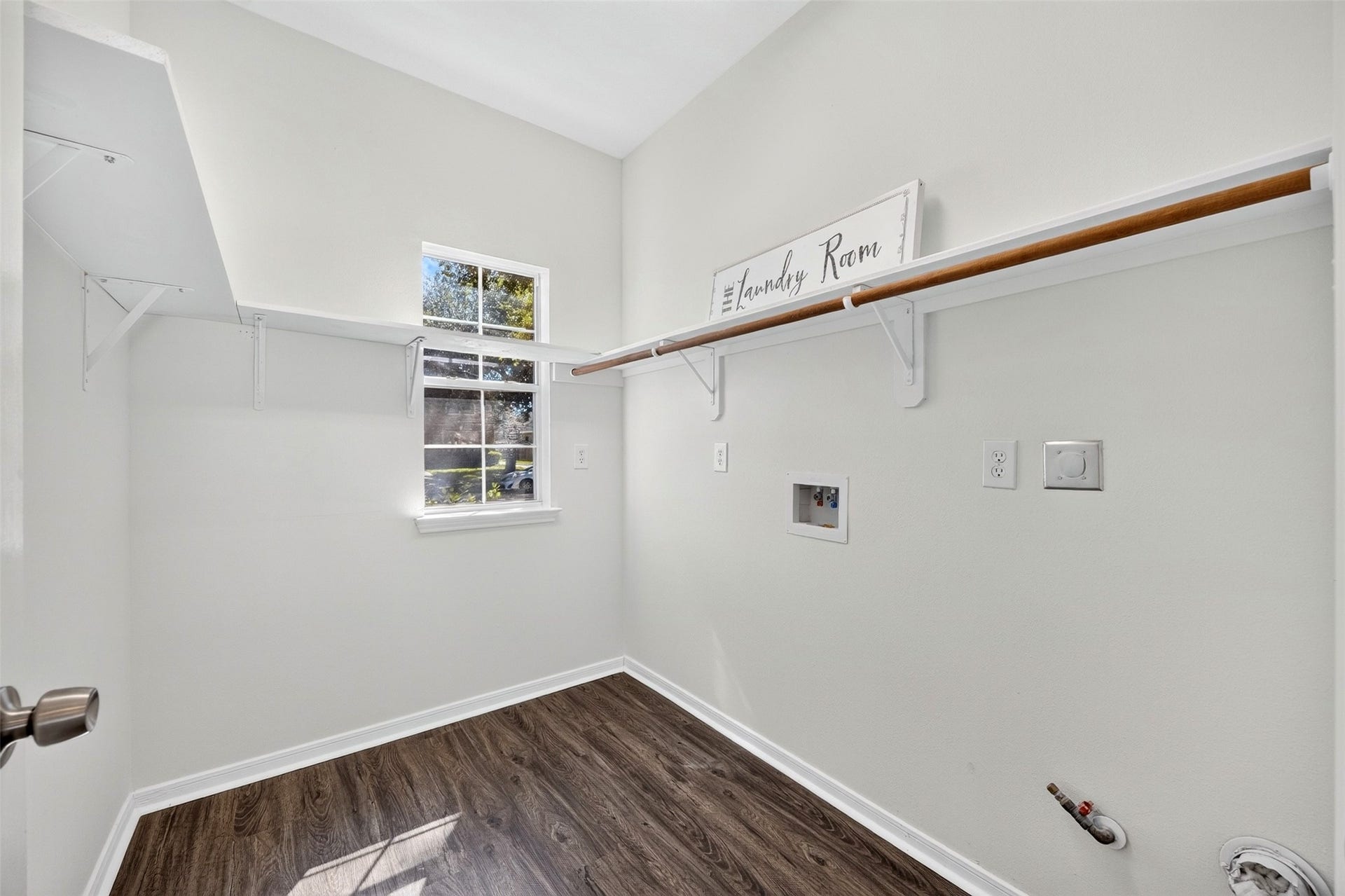 3114 Brannon Hill Lane, Sugar Land, TX 77479 Laundry room with ample shelving and a convenient window for natural light.