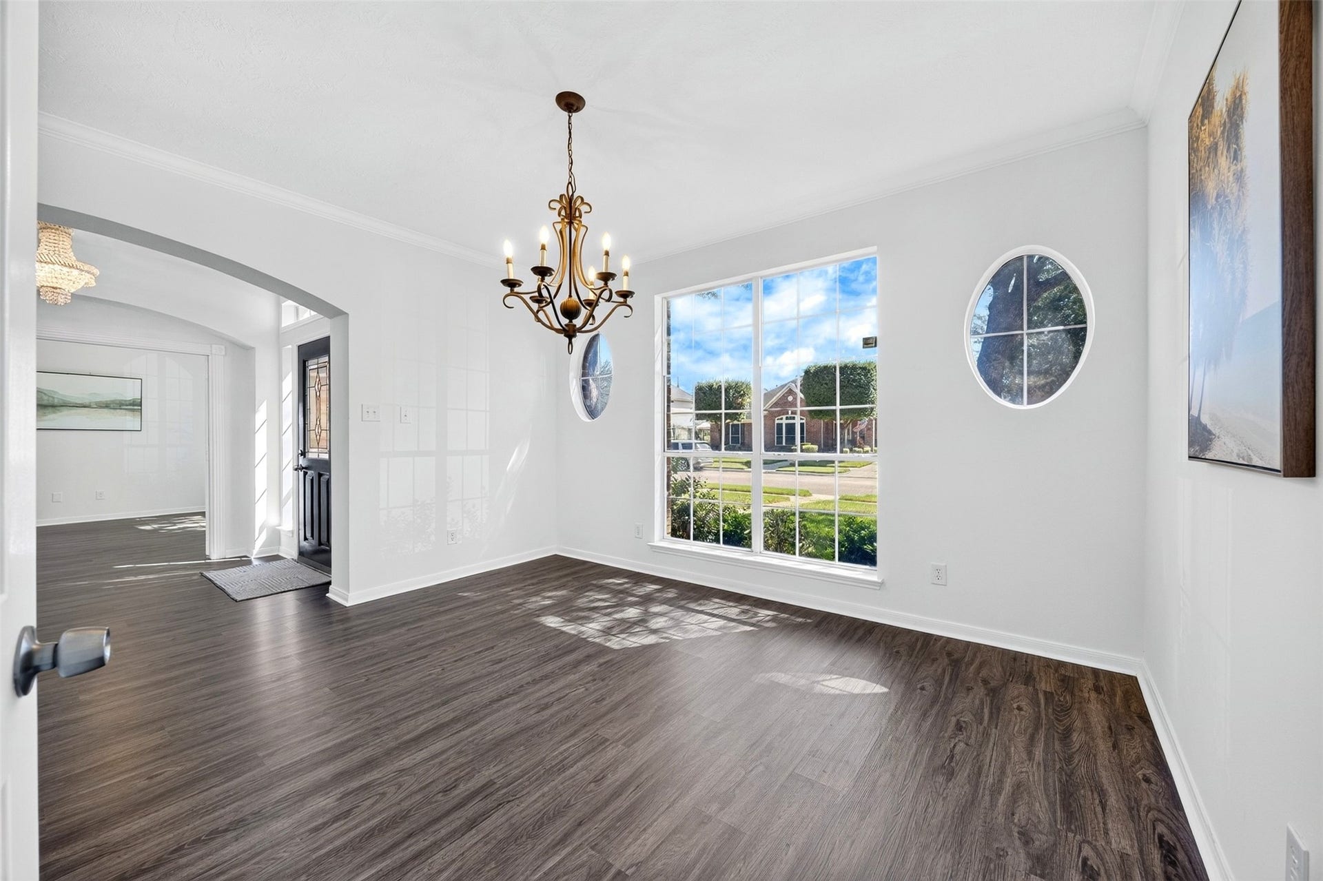 3114 Brannon Hill Lane, Sugar Land, TX 77479 Bright and airy dining room with large windows and an elegant chandelier, perfect for gatherings