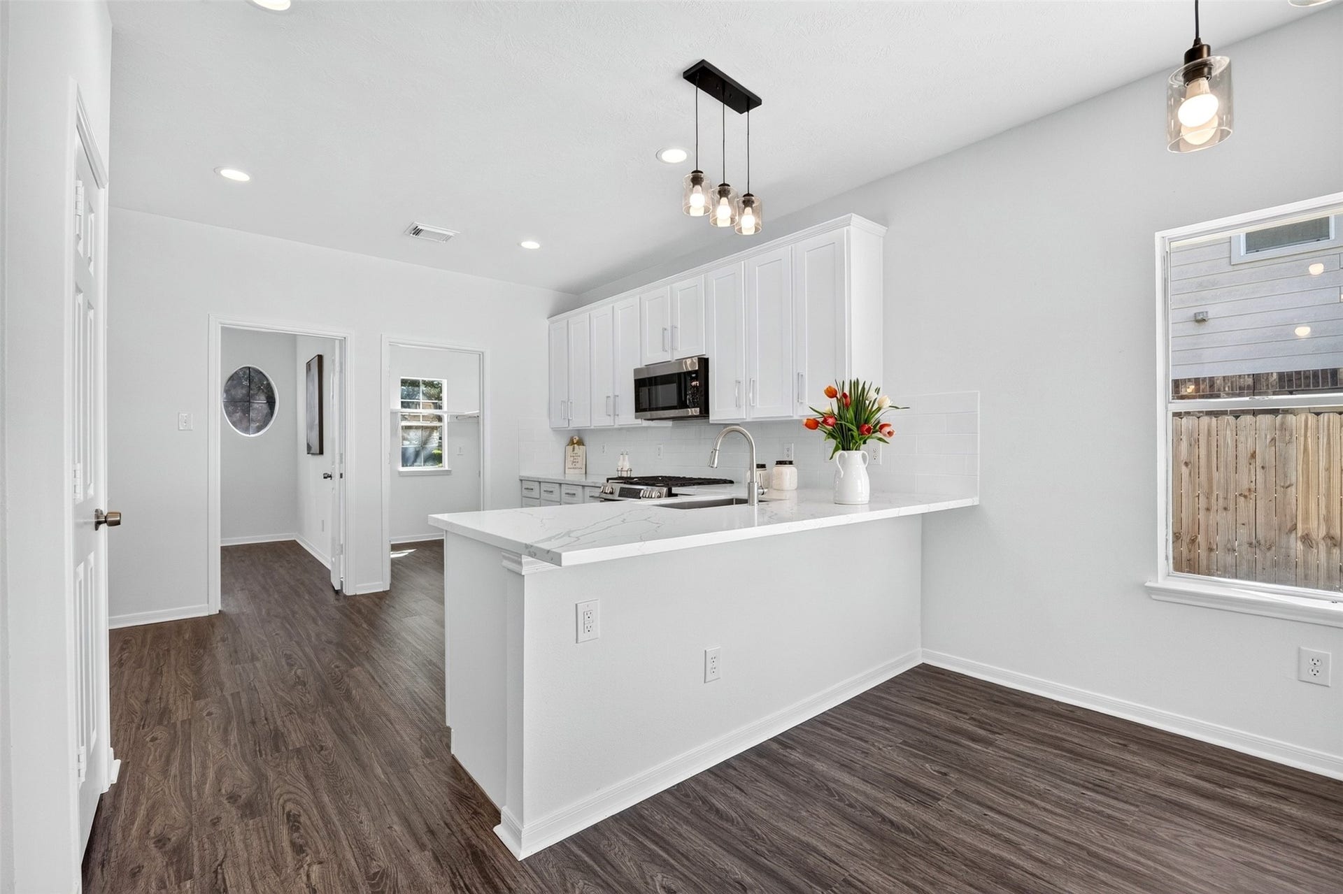 3114 Brannon Hill Lane, Sugar Land, TX 77479 Bright, modern kitchen with sleek white cabinetry and elegant pendant lighting, offering a welcoming space for cooking and entertaining.