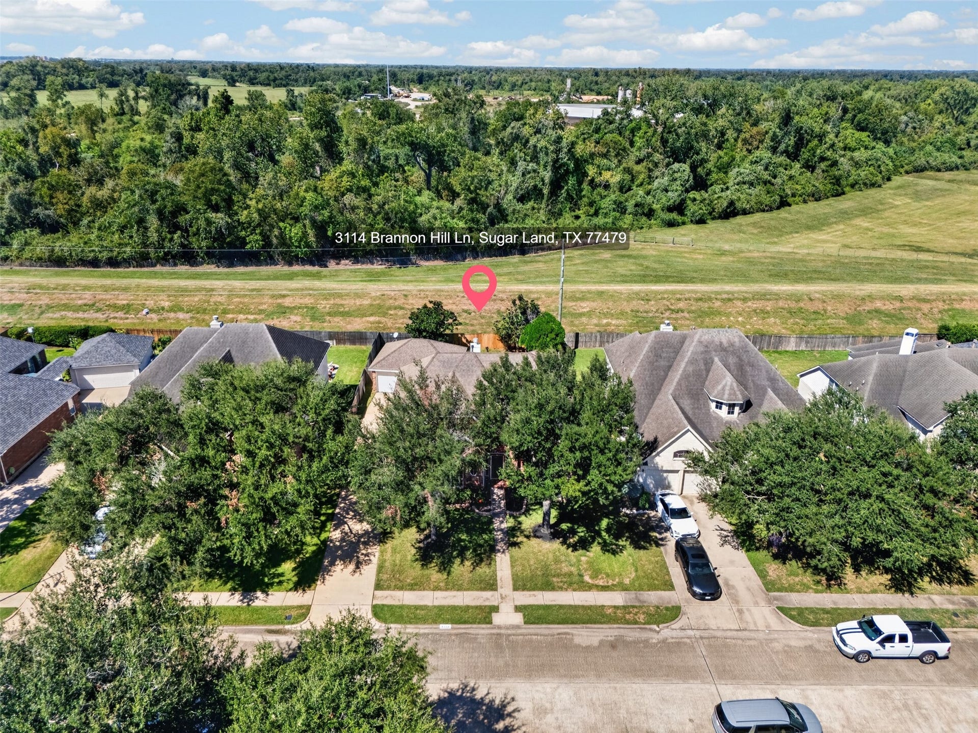 3114 Brannon Hill Lane, Sugar Land, TX 77479 Charming home nestled in a serene neighborhood, surrounded by lush greenery and offering peaceful views of expansive open fields.