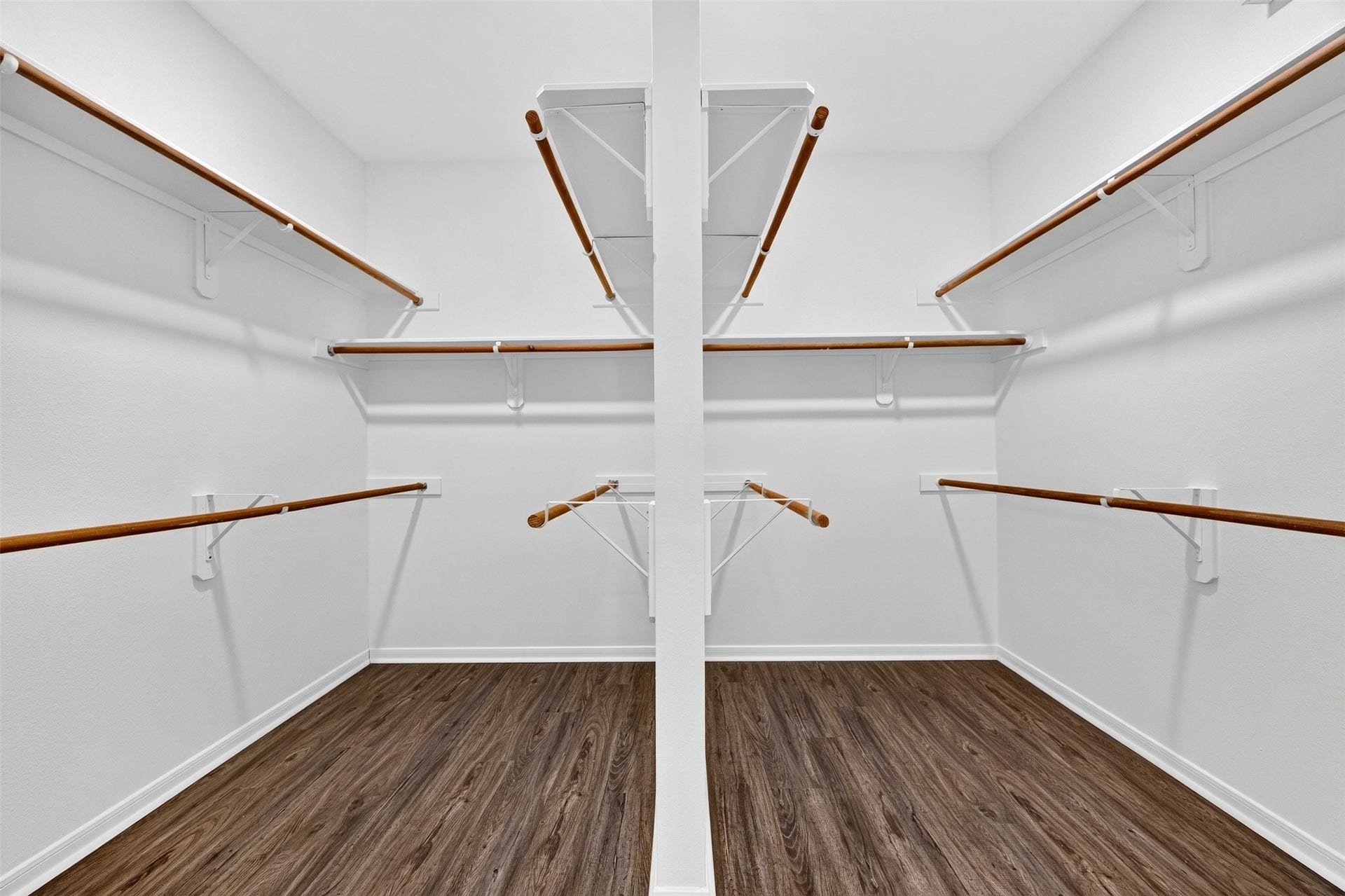 3114 Brannon Hill Lane, Sugar Land, TX 77479 Spacious walk-in closet with multiple hanging rods, perfect for organizing your wardrobe.