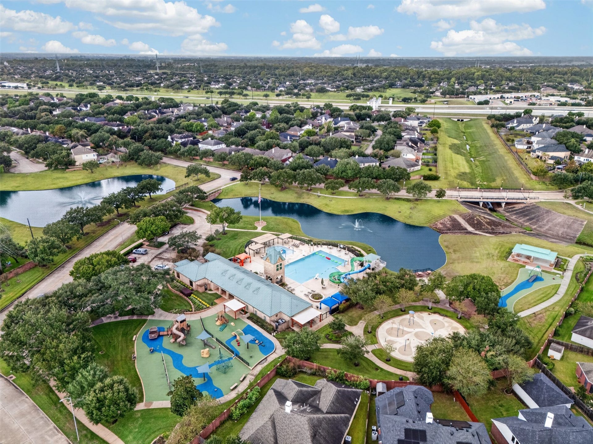 3114 Brannon Hill Lane, Sugar Land, TX 77479 Discover a vibrant community featuring a spacious recreational area with a large swimming pool, playgrounds, and scenic water views, perfect for family fun and relaxation.