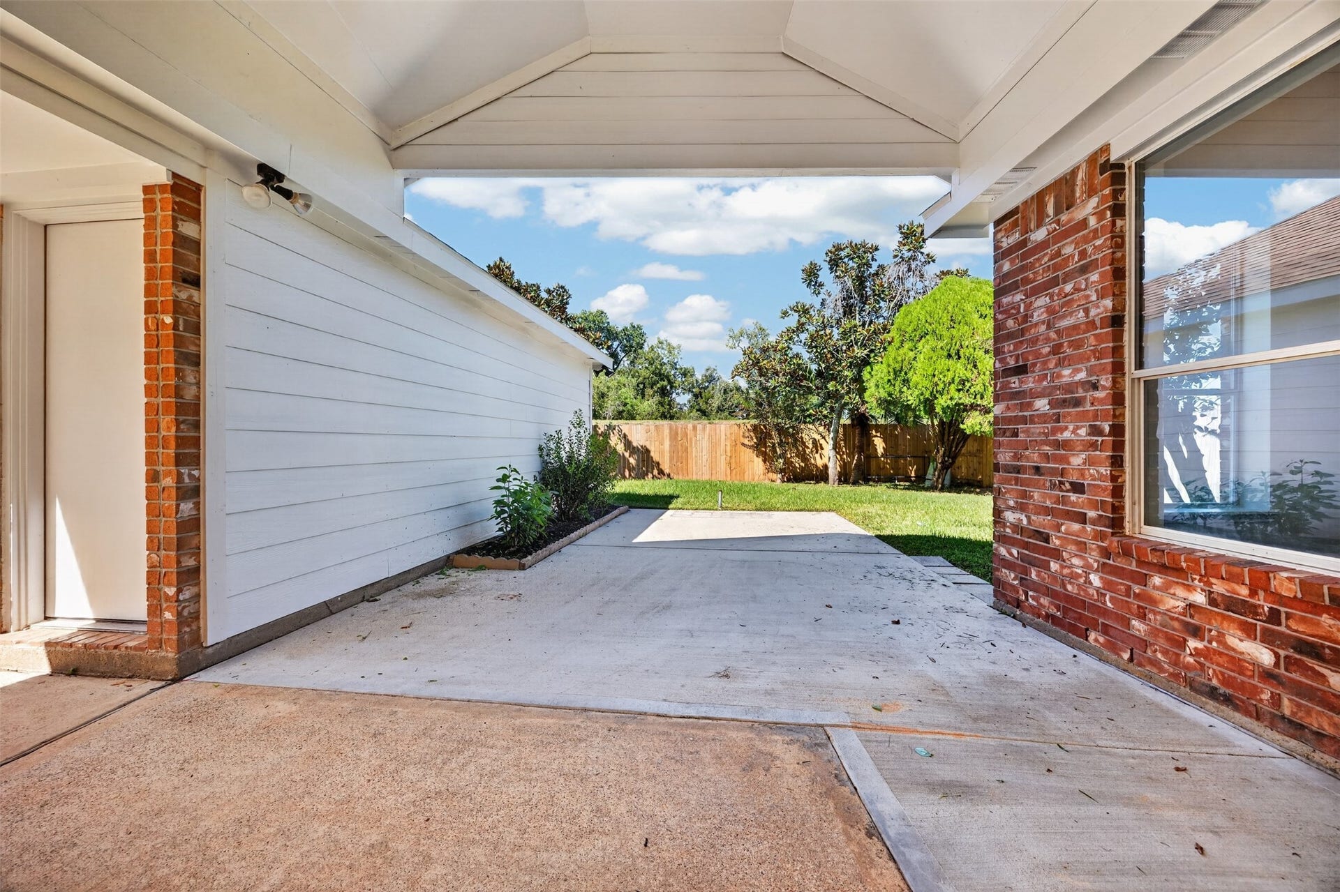 3114 Brannon Hill Lane, Sugar Land, TX 77479 Spacious backyard patio, perfect for outdoor entertaining, complemented by a lush green lawn and privacy fencing.