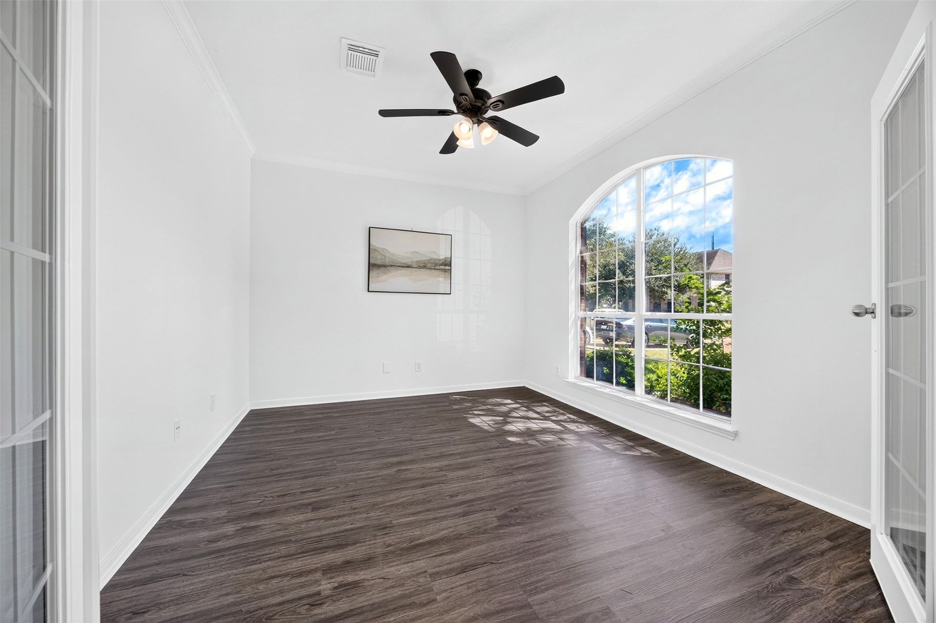 3114 Brannon Hill Lane, Sugar Land, TX 77479 Spacious office room with elegant French doors and a ceiling fan, offering a versatile space filled with natural light