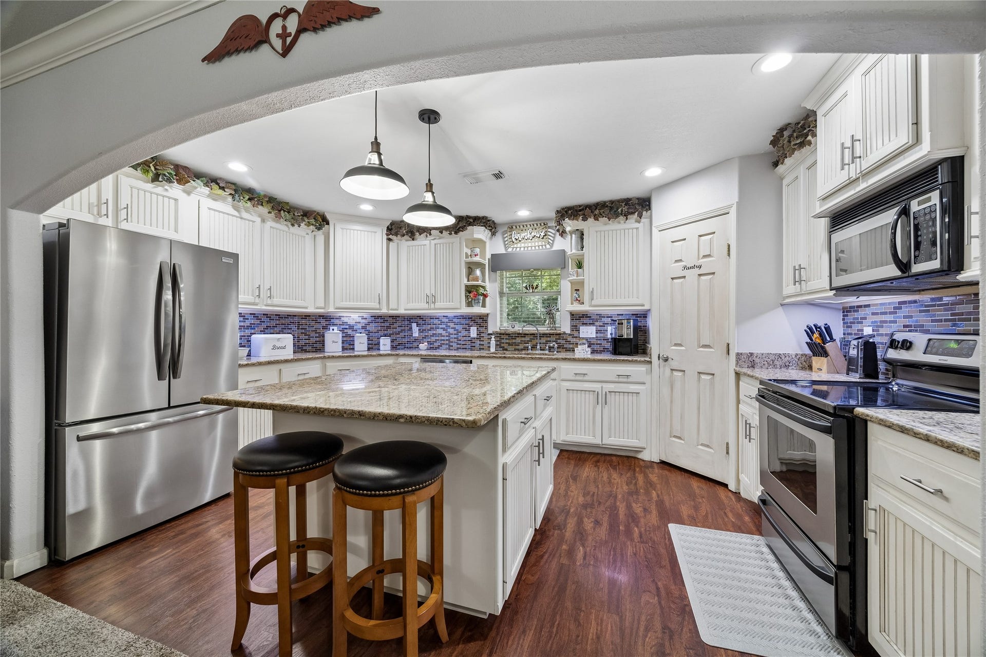 26904 Brentwood Road, Splendora, TX 77372 The kitchen features beautiful cabinetry, granite countertops, and a large center island