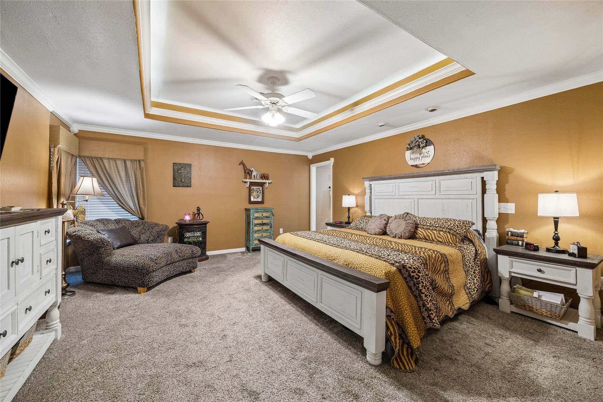 26904 Brentwood Road, Splendora, TX 77372 The primary suite showcases a beautiful tiered ceiling design and a central ceiling fan