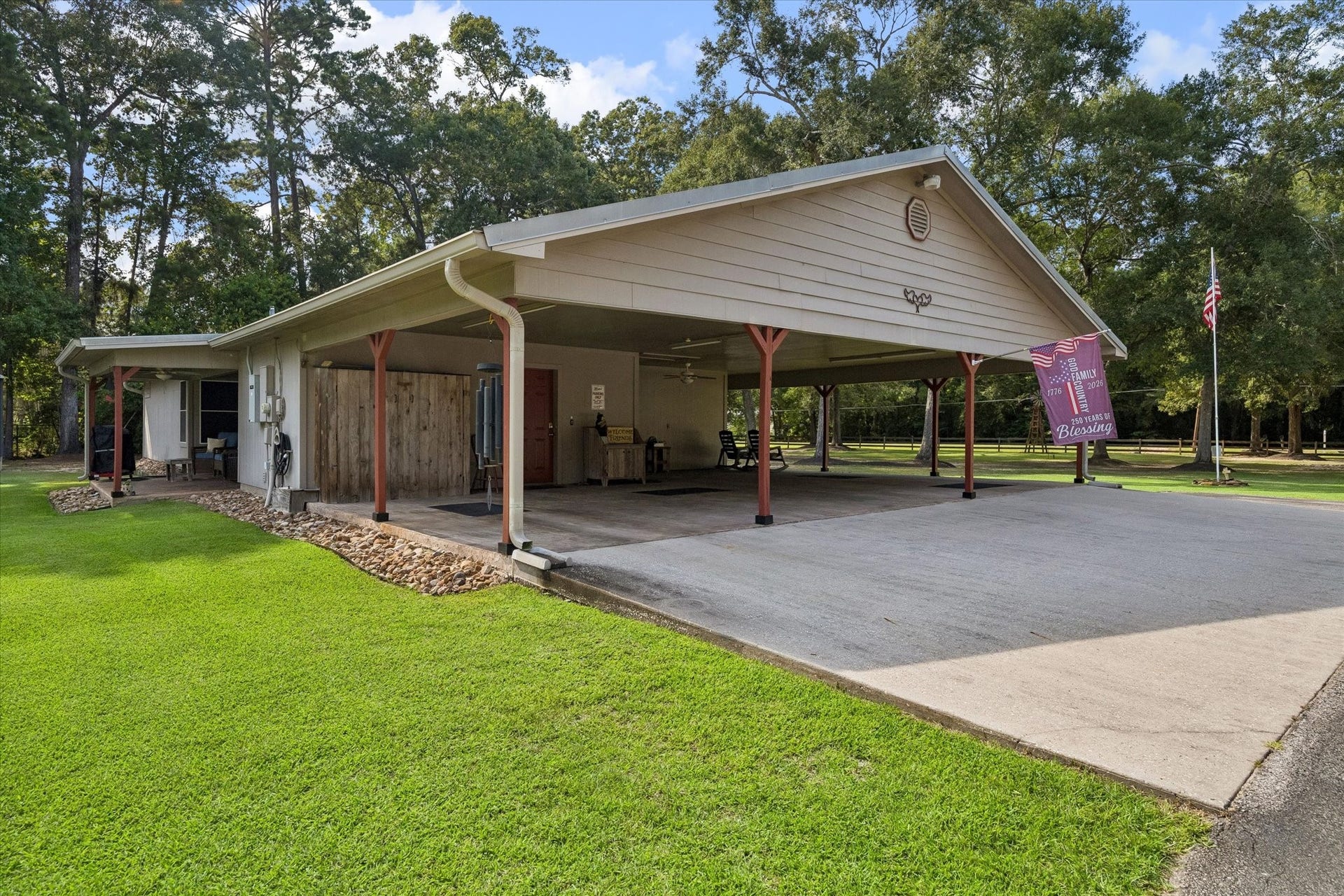 26904 Brentwood Road, Splendora, TX 77372 Three-car carport and glimpz of covered back patio view of the main home