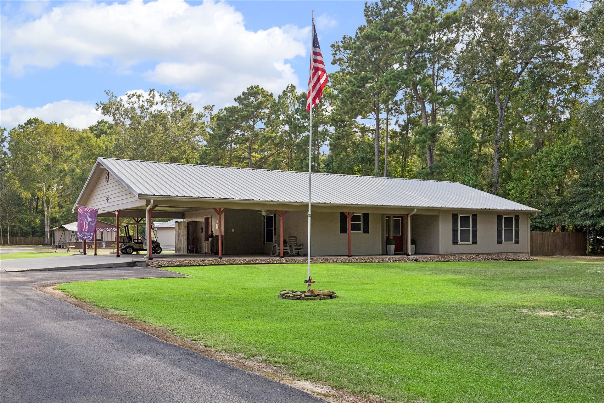 26904 Brentwood Road, Splendora, TX 77372 Situated on two and a half acres, the main house offers a picturesque setting complete with a classic flagpole and a charming windmill