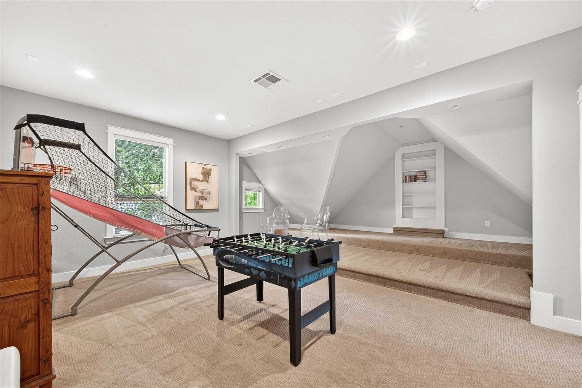 The media room is another play area or can be a movie room. The secret door leads you to an abundance of attic storage and space!