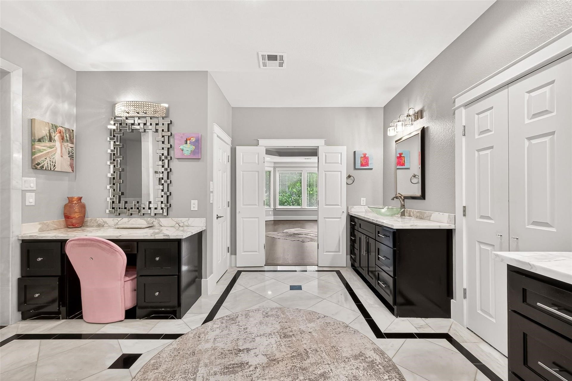 The primary bathroom features 2 sinks and 3 vanity areas. Luxurious marble flooring throughout.