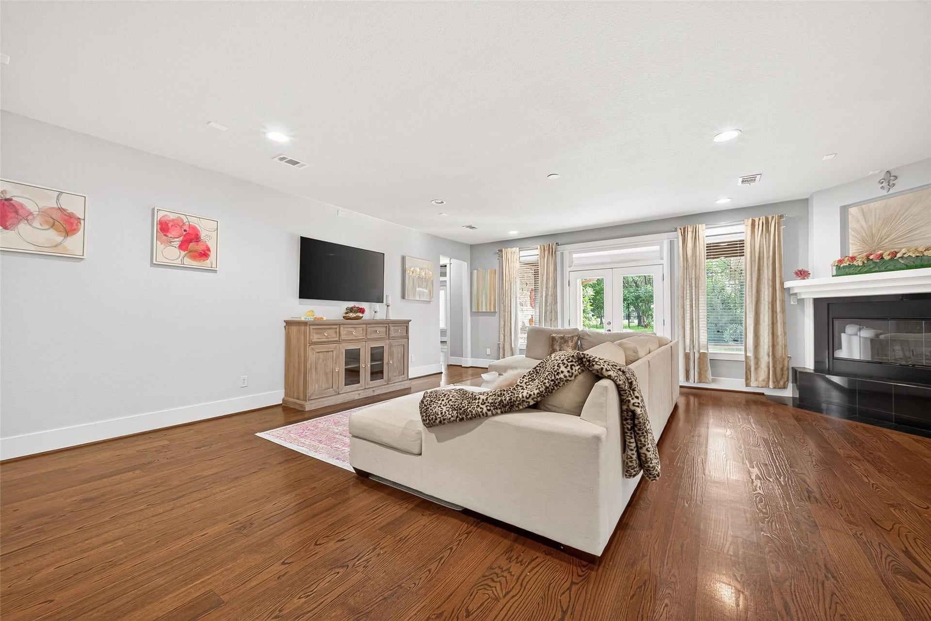 Another view of family room with a charming gas and wood burning fireplace.