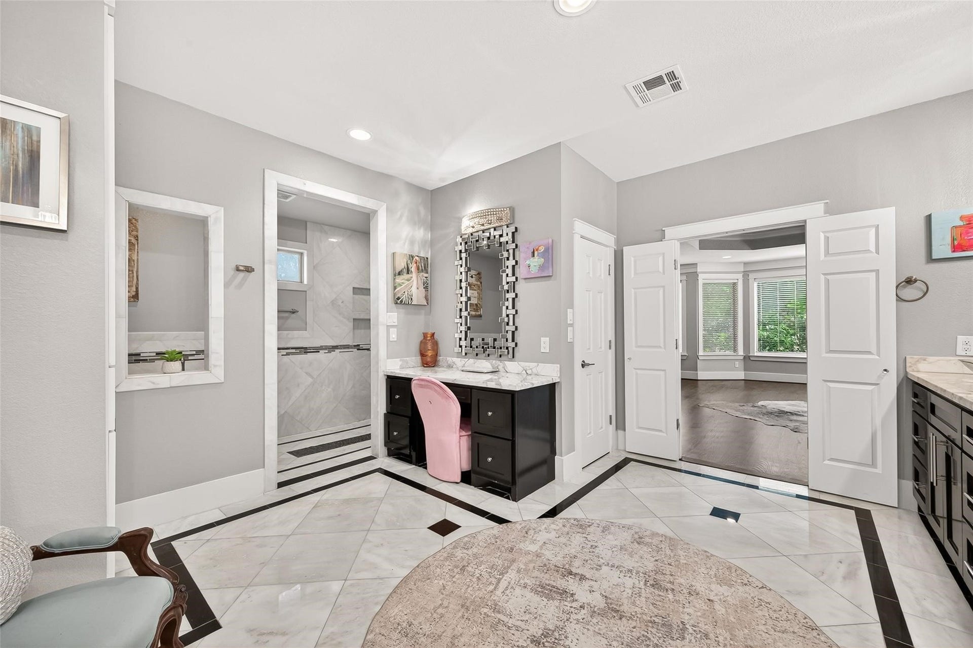 Bathroom features a marble soaking tub and huge separate shower with bench.