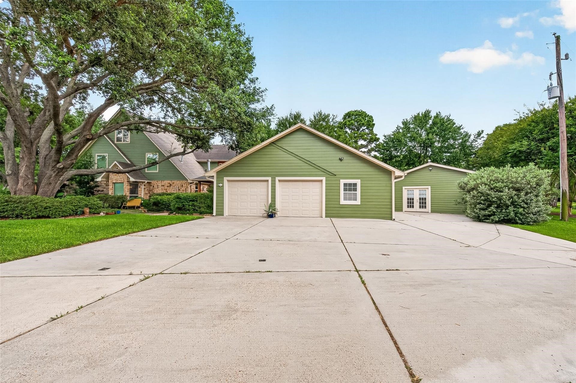 The garage is located on the side of the house with a huge driveway and additional private guest house parking.