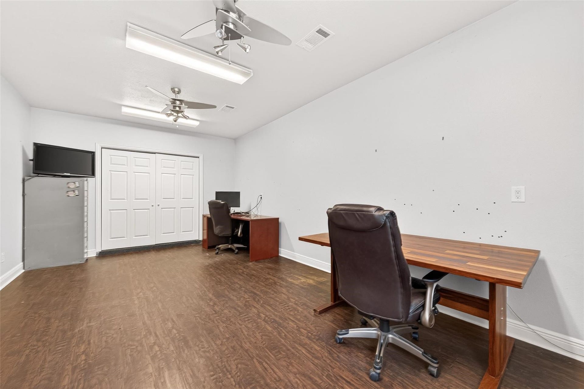 Another view of garage office space and closet for storage. Outdoor space is wired for cameras