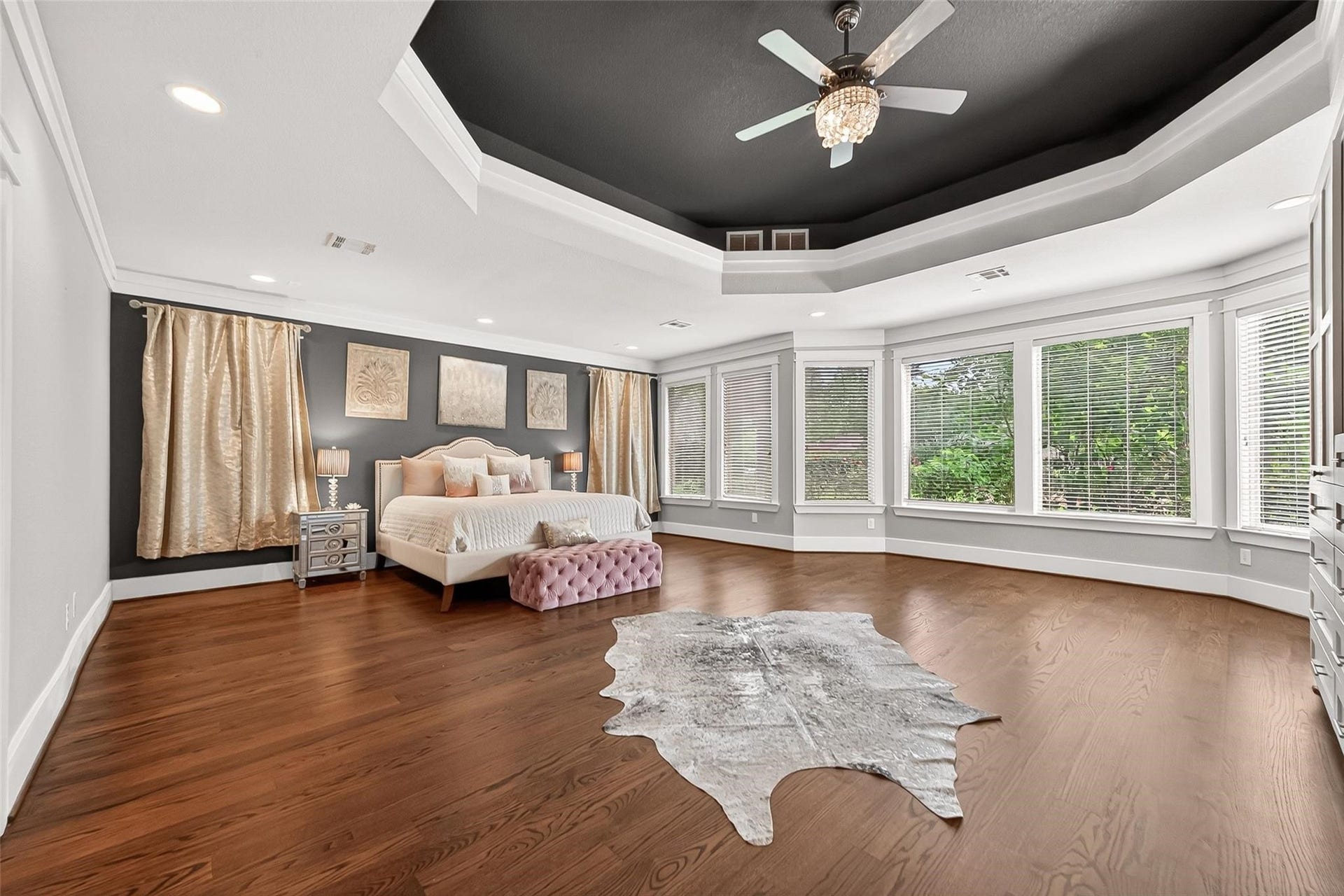 The HUGE Primary bedroom that is located in the back of the house with a backyard view.