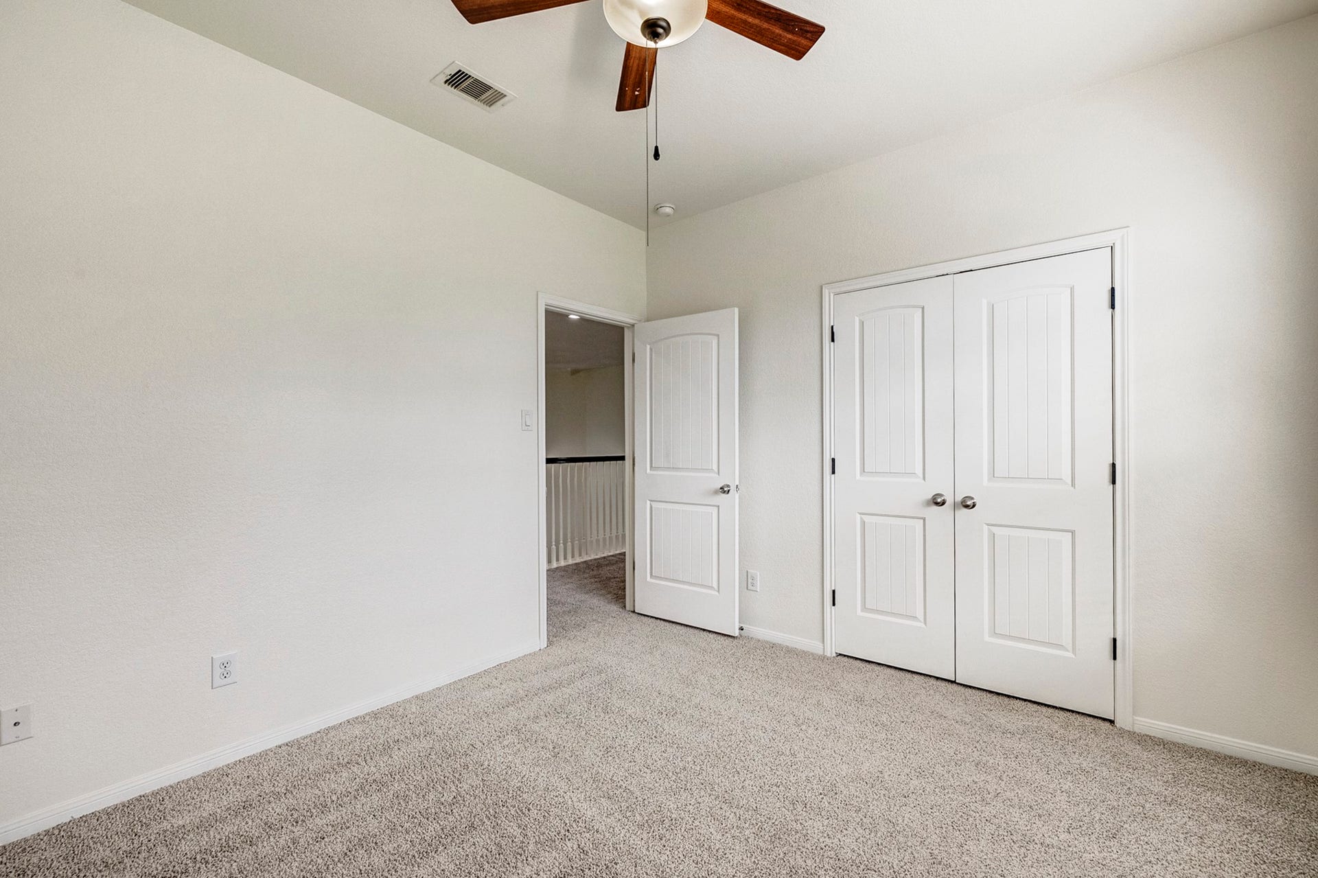 33227 Greenfield Forest Drive, Magnolia, TX 77354 Bright, spacious bedroom featuring plush carpeting, a ceiling fan, and ample closet space with double doors.