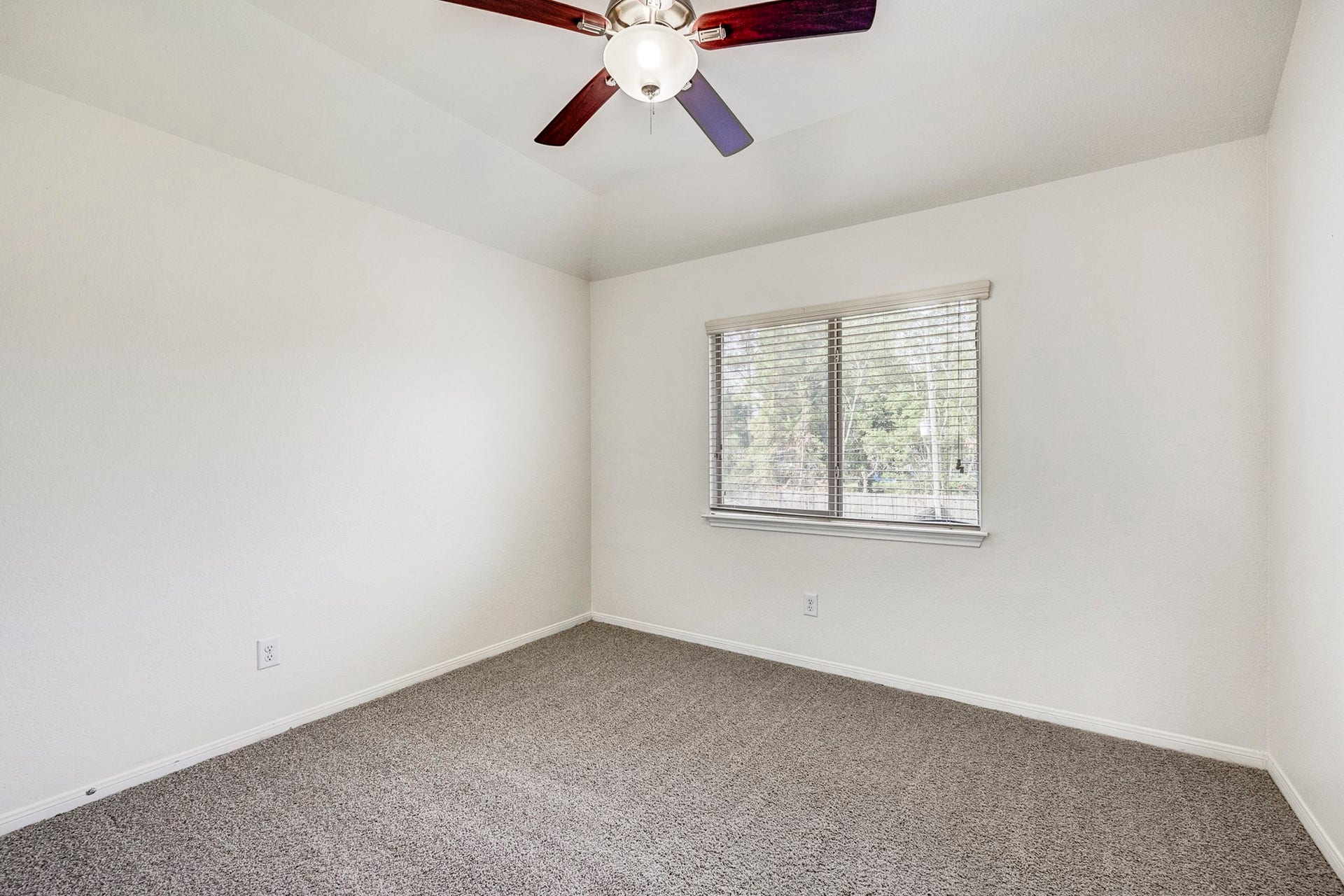 33227 Greenfield Forest Drive, Magnolia, TX 77354 Bright and airy bedroom featuring a ceiling fan, plush carpeting, and a large window for natural light.