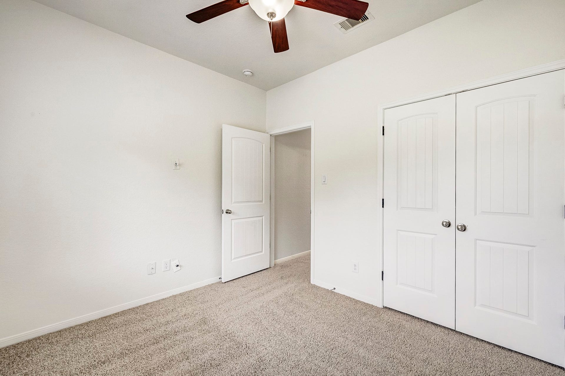 33227 Greenfield Forest Drive, Magnolia, TX 77354 Bright and cozy bedroom featuring plush carpeting, a ceiling fan, and ample closet space with double doors.