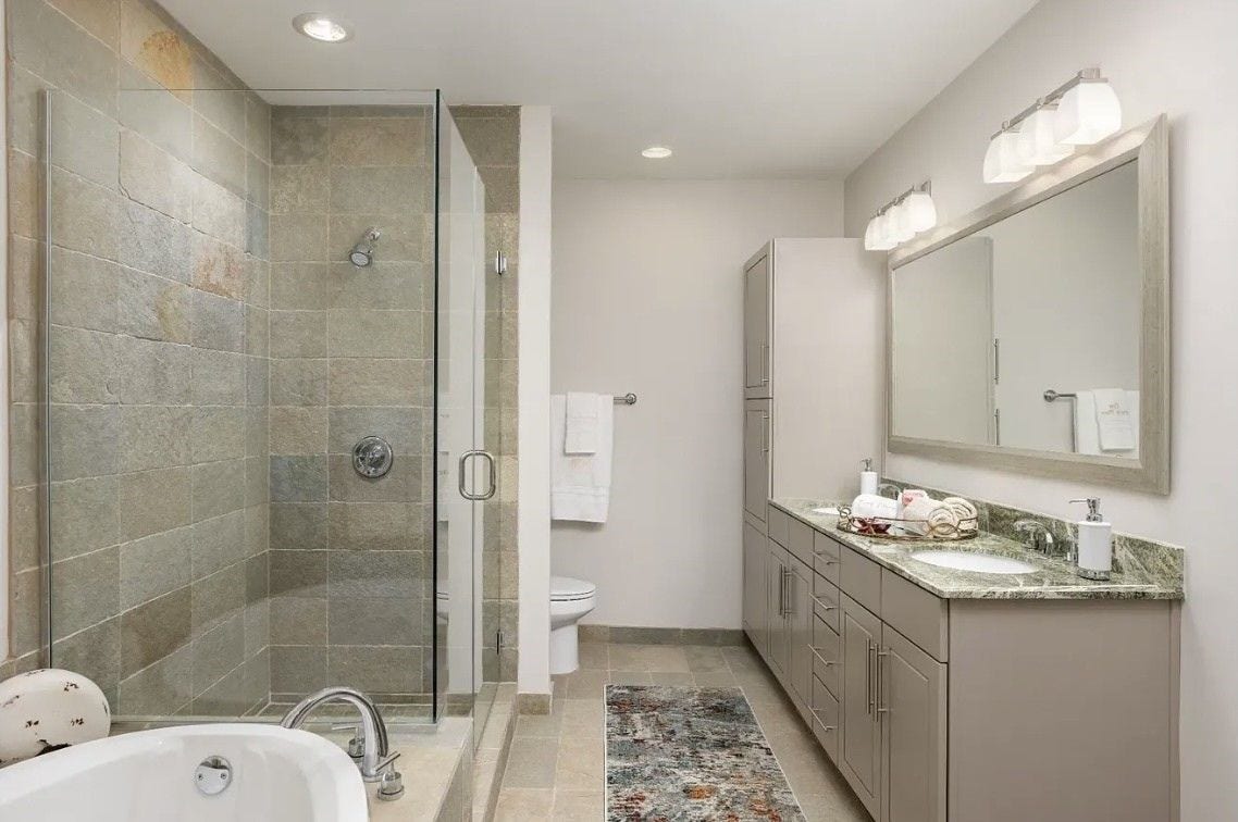 1400 McKinney Street, #3204, Houston, TX 77010 The luxurious primary bathroom is thoughtfully designed with a dual-sink vanity, granite countertops, abundant cabinet storage and contemporary finishes throughout. The spacious layout creates a bright, elegant retreat for everyday comfort and convenience.