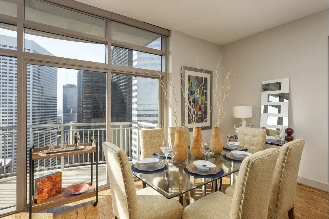 1400 McKinney Street, #3204, Houston, TX 77010 Enjoy every meal with breathtaking downtown views from the beautifully appointed dining area. Floor-to-ceiling windows flood the space with natural light while seamlessly connecting indoor living with the vibrant city skyline, creating the perfect setting for intimate dinners or entertaining guests.