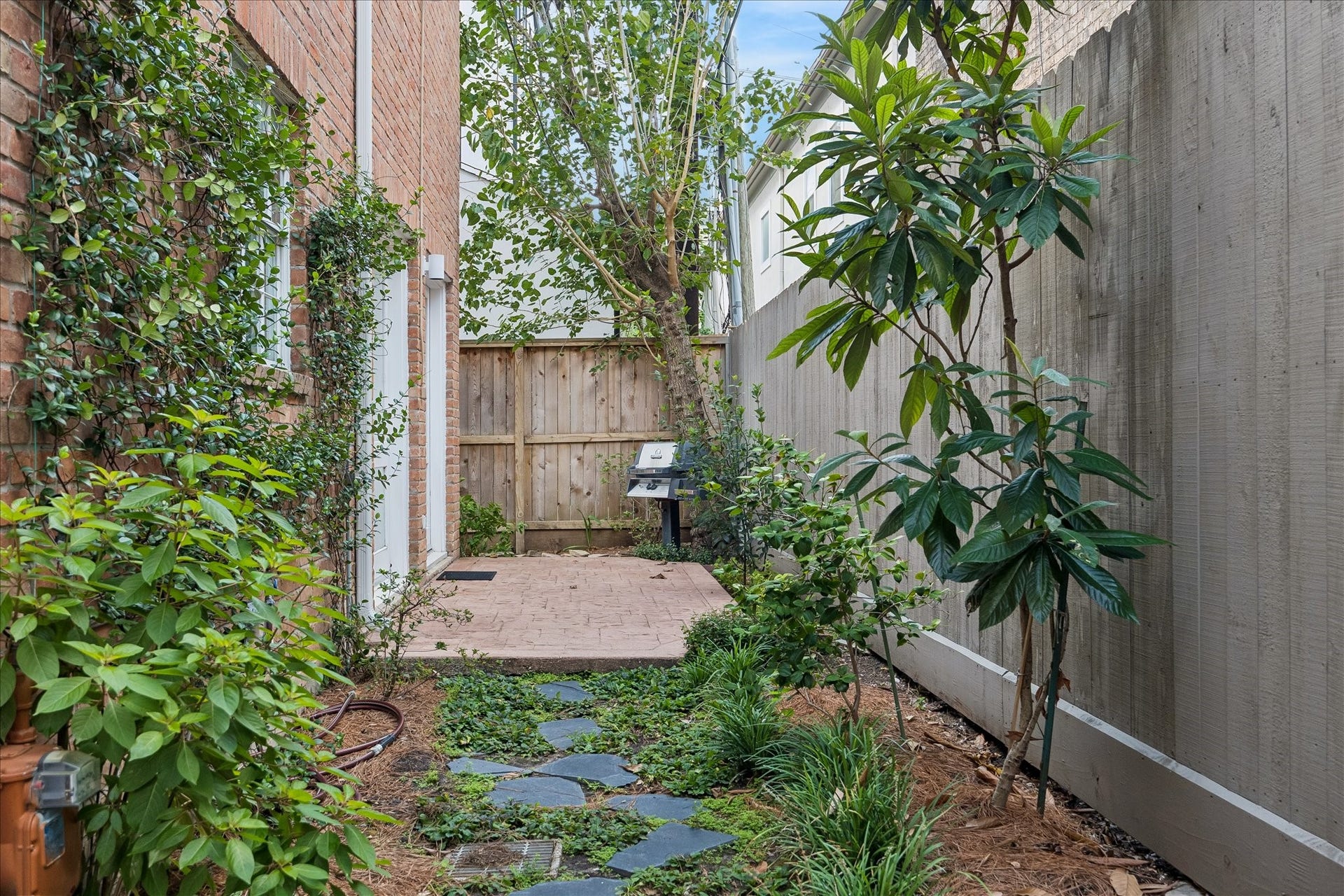 1422 Nantucket Drive, #C, Houston, TX 77057 Fully fenced rear yard with patio and dedicated garden area, a rare second private outdoor space.