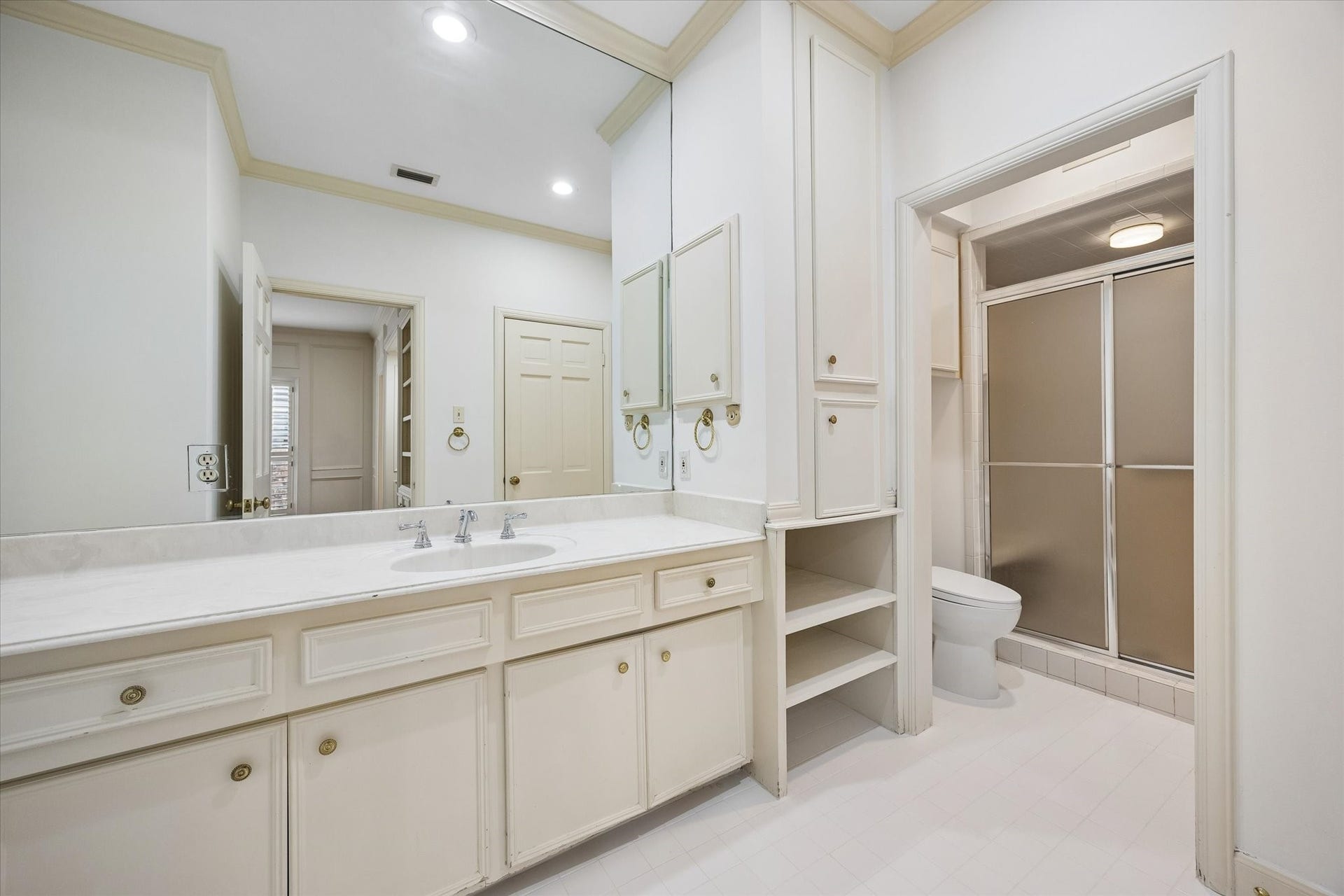 1422 Nantucket Drive, #C, Houston, TX 77057 Primary Bath Two, features a walk-in shower, extended counter space and built-in storage.