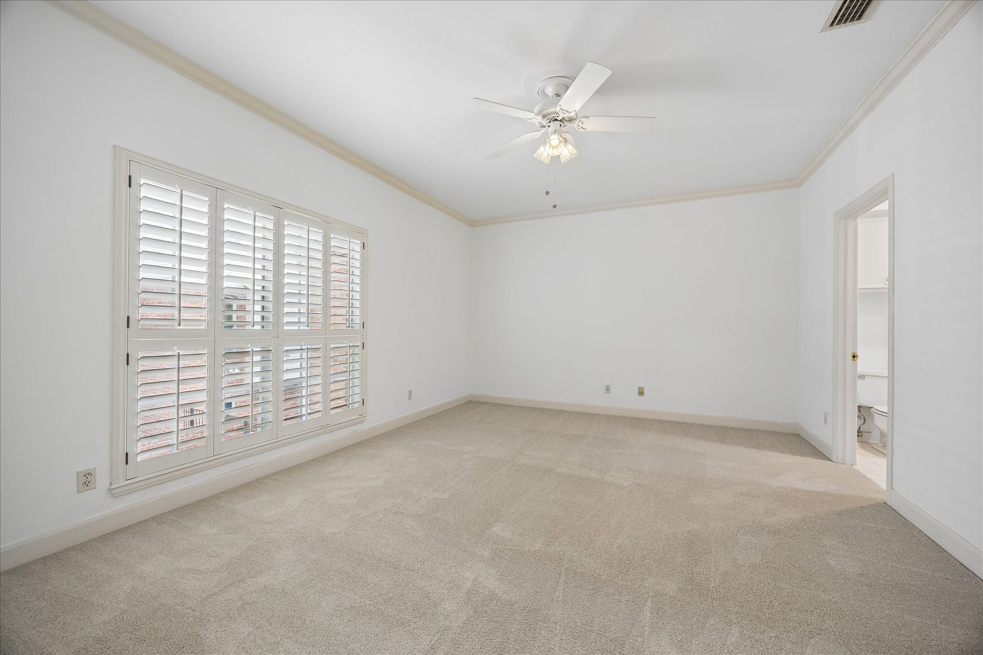 1422 Nantucket Drive, #C, Houston, TX 77057 Spacious secondary bedroom with window shutters, abundant natural light and en-suite bath.