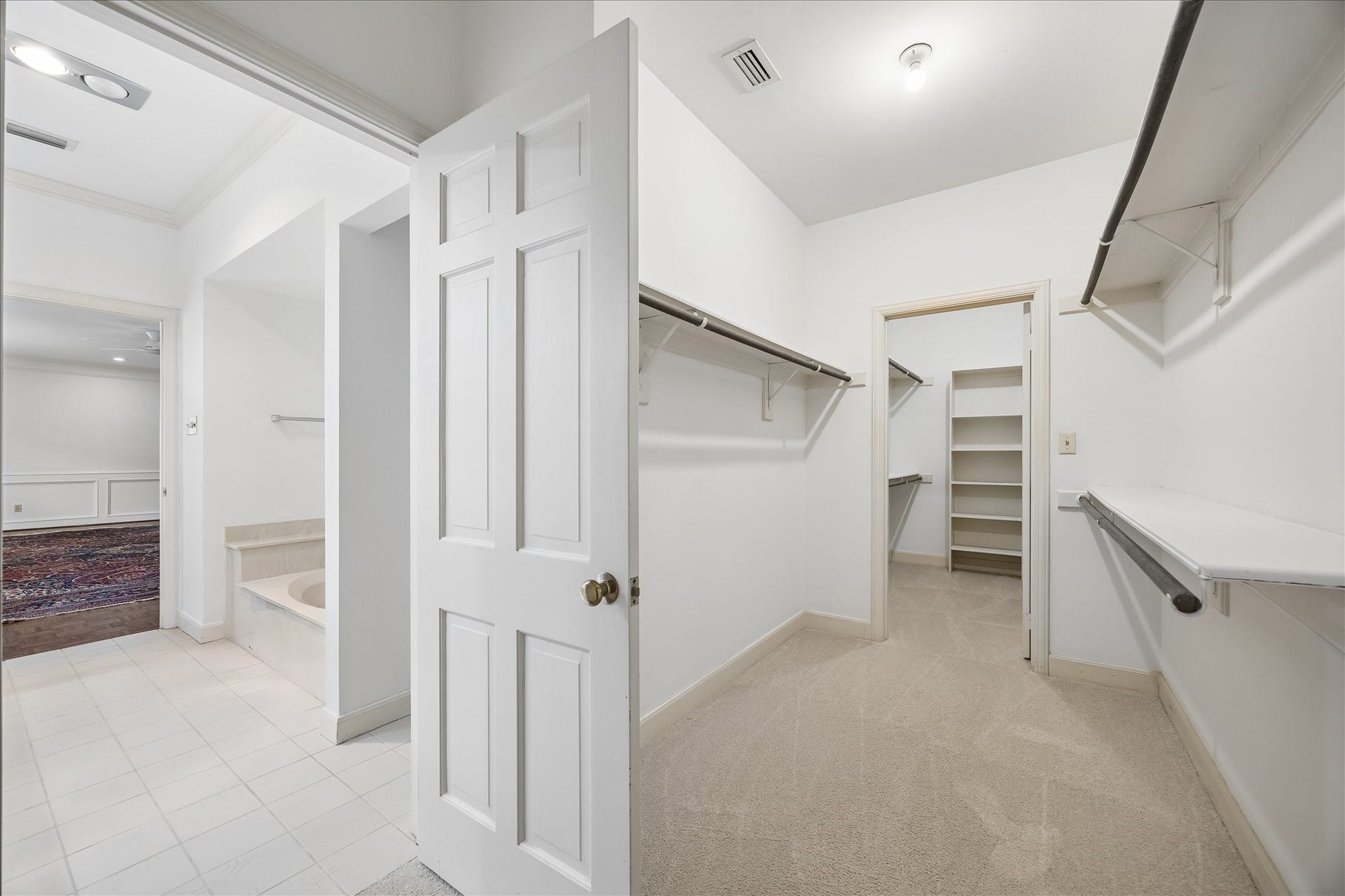 1422 Nantucket Drive, #C, Houston, TX 77057 One of two spacious walk-in primary closets with generous hanging space and built-in shelving.