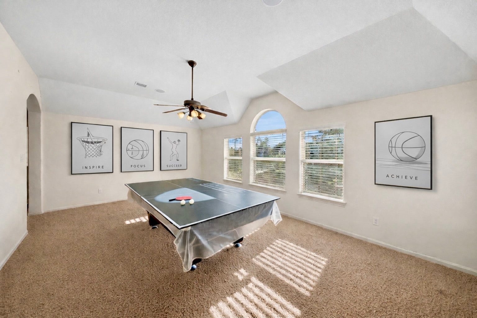 14318 Red Creek Cove Lane, Humble, TX 77396 This bright, spacious game room features a ping pong and pool table with large windows for natural light.