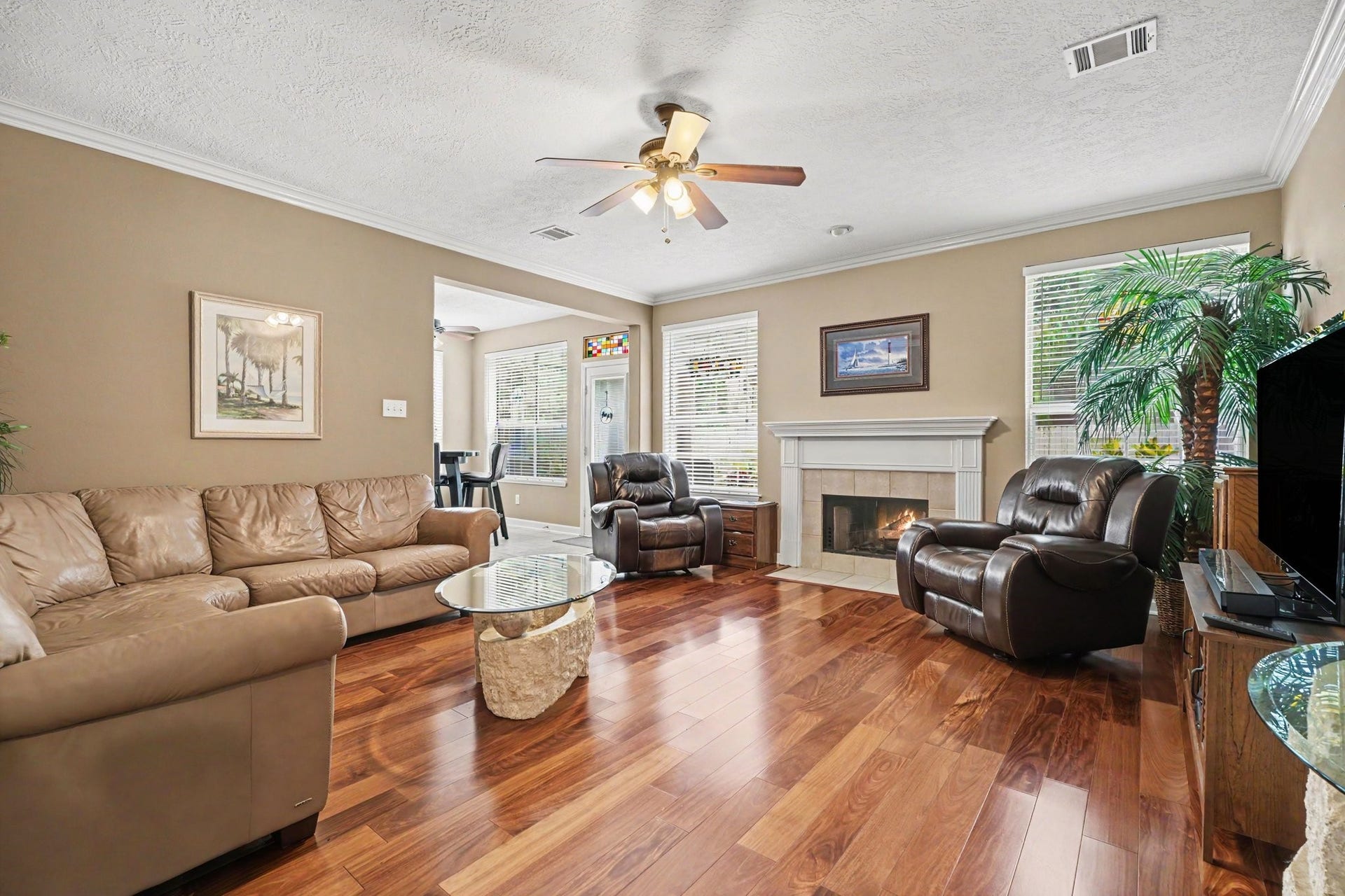 2123 Autumn Cove Drive, League City, TX 77573 Living room off of kitchen and breakfast area with beautiful wood floors and fireplace.