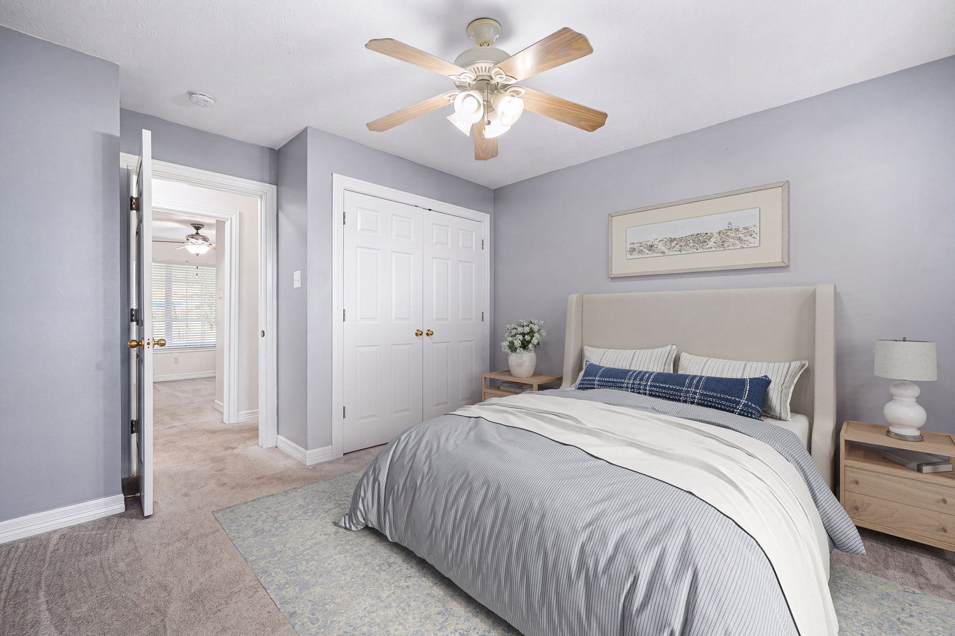 28310 Rose Lane, Katy, TX 77494 Comfortable and inviting secondary bedroom featuring a serene neutral color palette and plush carpeting. The space includes a large double-door closet providing ample storage, crisp white trim work, and a classic central ceiling fan with an integrated light fixture. An open doorway connects to the hallway, highlighting a highly functional floor plan ideal for family members or guests.