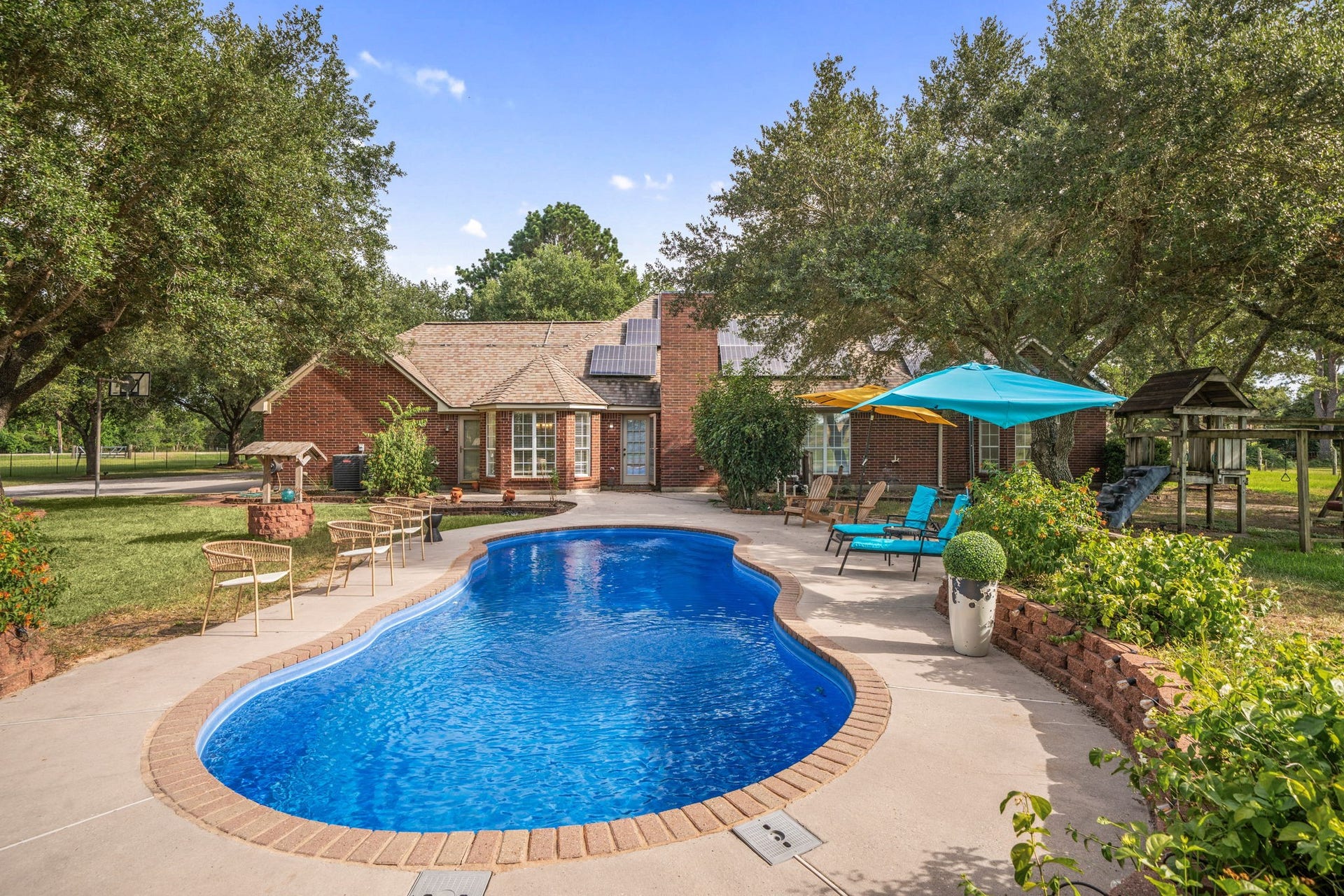 28310 Rose Lane, Katy, TX 77494 Beautifully landscaped backyard retreat showcasing a sparkling in-ground pool framed by custom brick trim. The expansive concrete decking creates an ideal layout for open-air entertaining, complemented by low-maintenance raised stone garden beds. Towering mature trees line the property, providing an abundance of natural shade and a high degree of privacy for the entire outdoor area.
* Wo