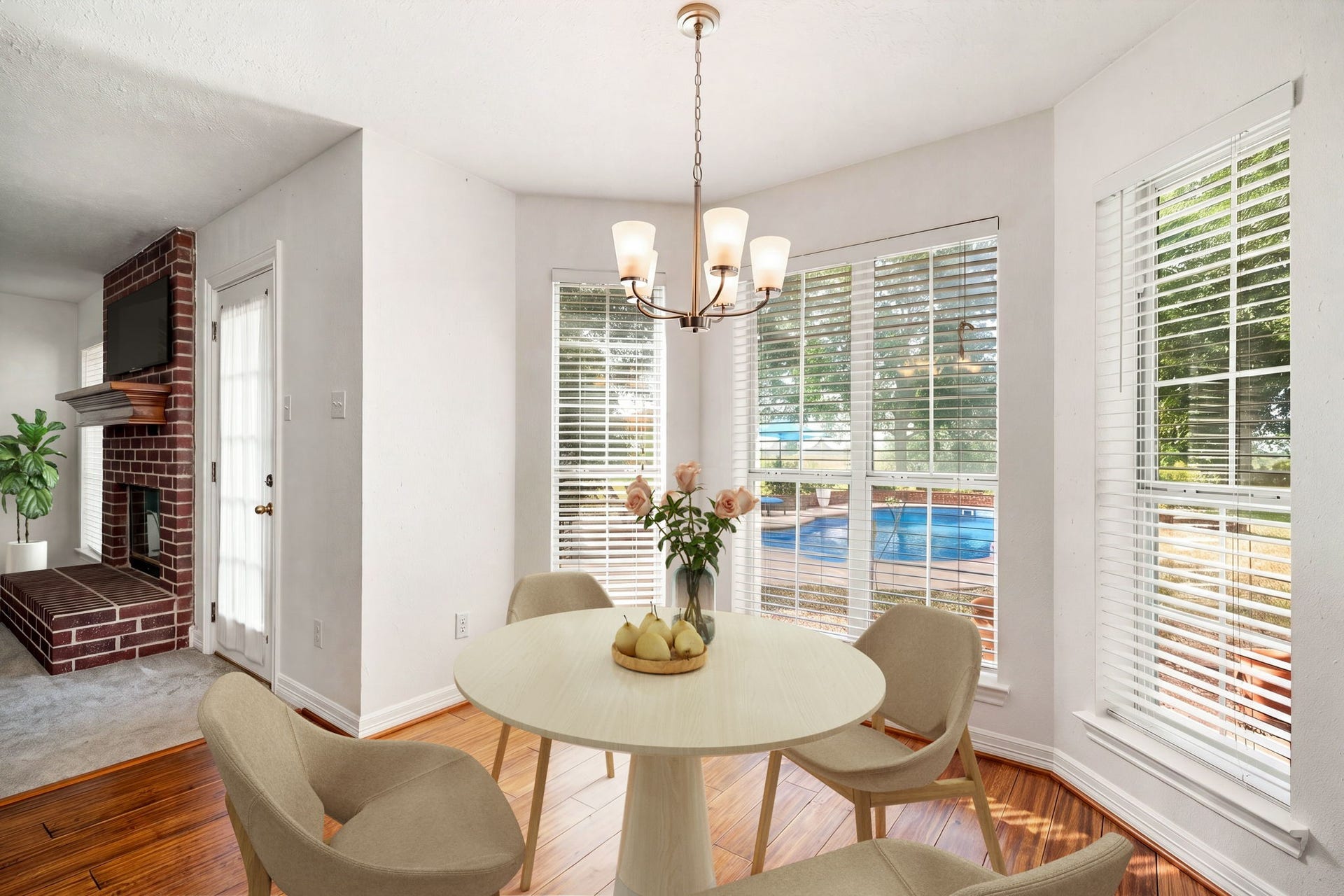 28310 Rose Lane, Katy, TX 77494 Sun-filled breakfast nook or dining alcove featuring a striking bay window design that overlooks the outdoor pool area. The bright space offers a classic multi-light hanging chandelier, warm wood-look flooring, and a seamless connection to the main living areas. Large, multi-pane windows flood the room with natural light, creating a picturesque setting for daily meals.