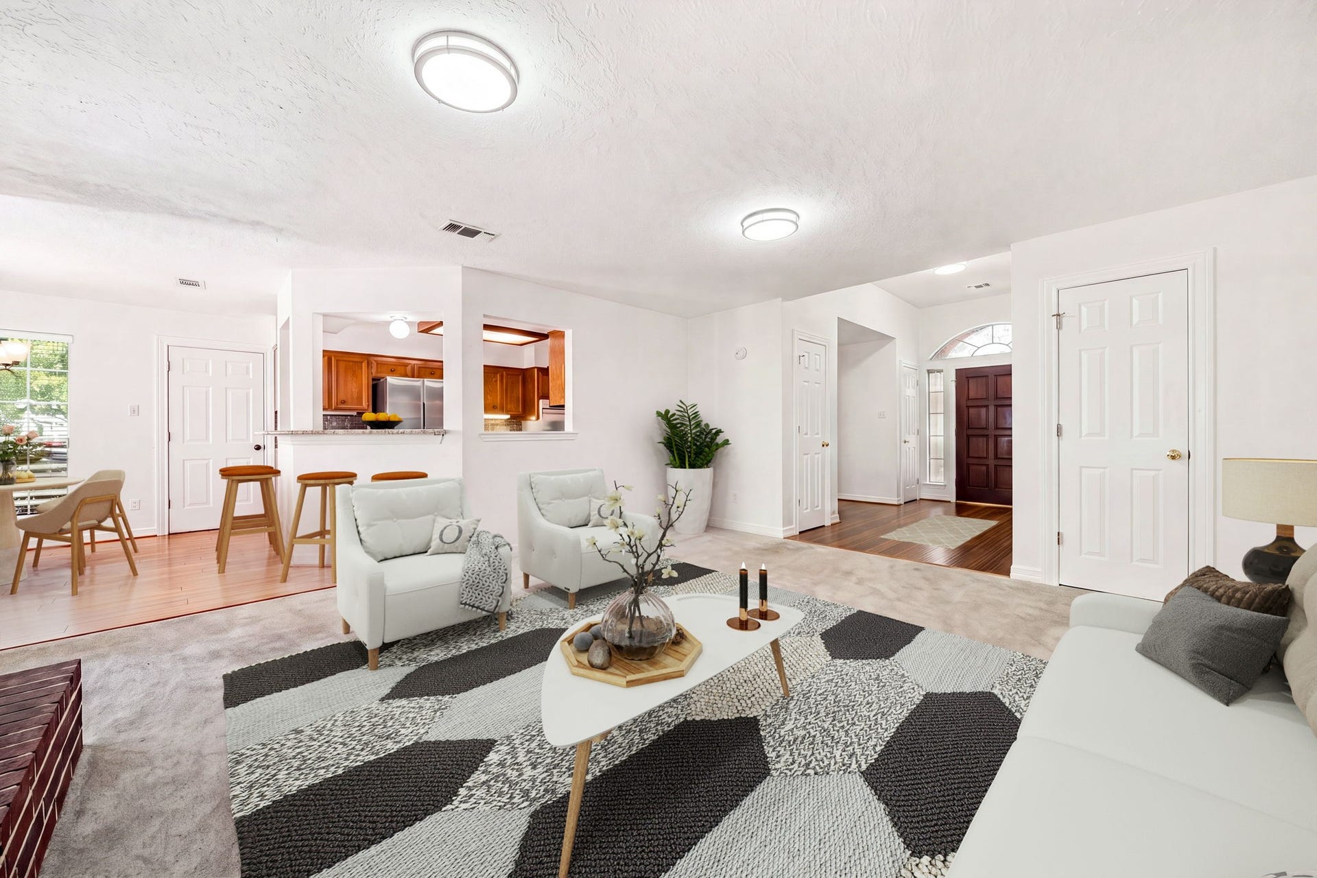 28310 Rose Lane, Katy, TX 77494 Bright, open-concept living area featuring a neutral color palette and seamless flow into the kitchen and dining spaces, perfect for entertaining. The expansive floor plan boasts plush carpeting, abundant natural light from large windows, and modern overhead lighting fixtures throughout.