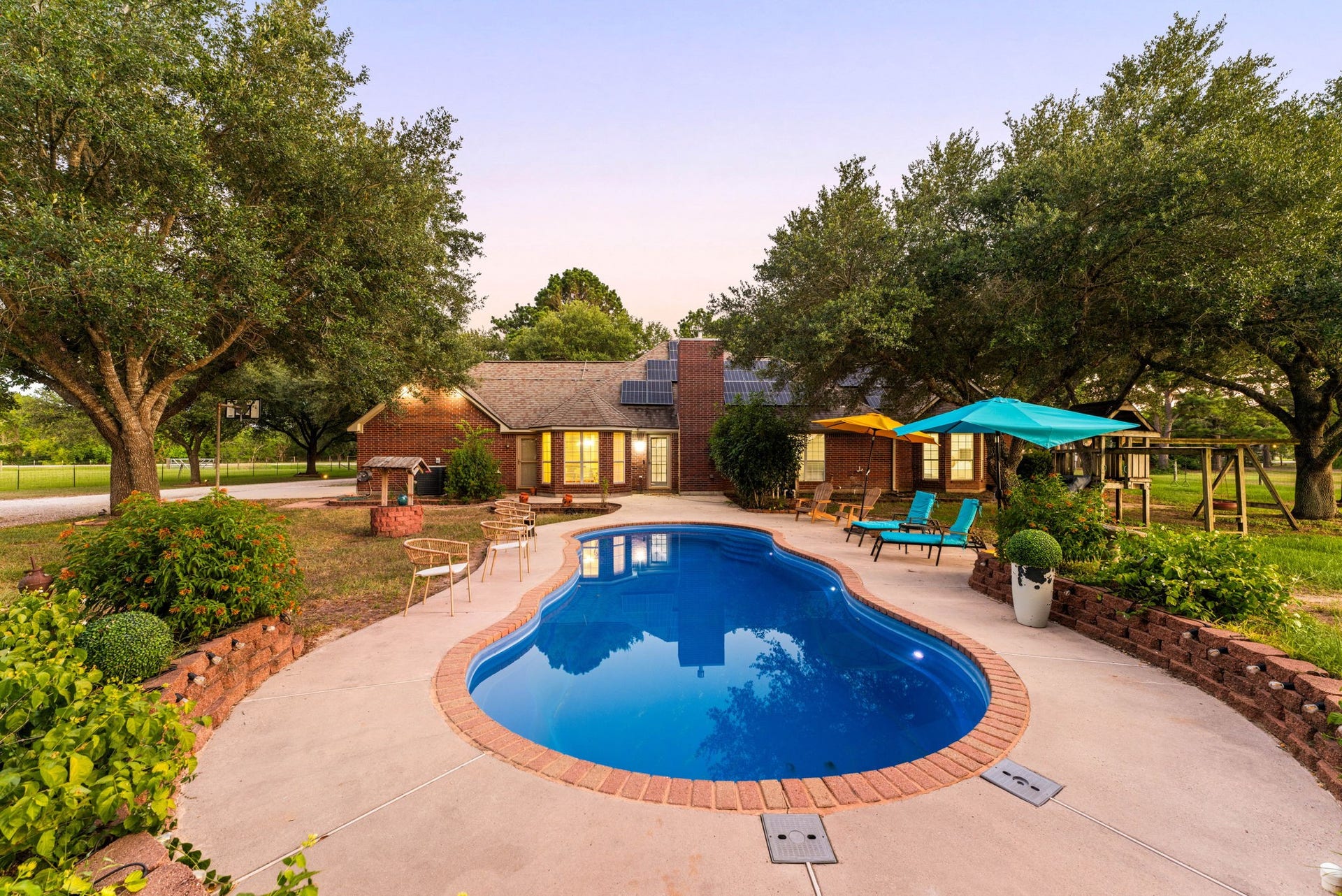 28310 Rose Lane, Katy, TX 77494 Escape to your own secluded piece of paradise, highlighted by a freeform in-ground pool wrapped in brick-paved coping. Sun-drenched concrete decking wraps around the water, while tiered stone retaining walls add depth and structure to the professional landscaping. Encircled by a perimeter of towering canopy trees, the vast lawn area offers the ultimate venue for summer pool parties or peaceful afternoon relaxation.