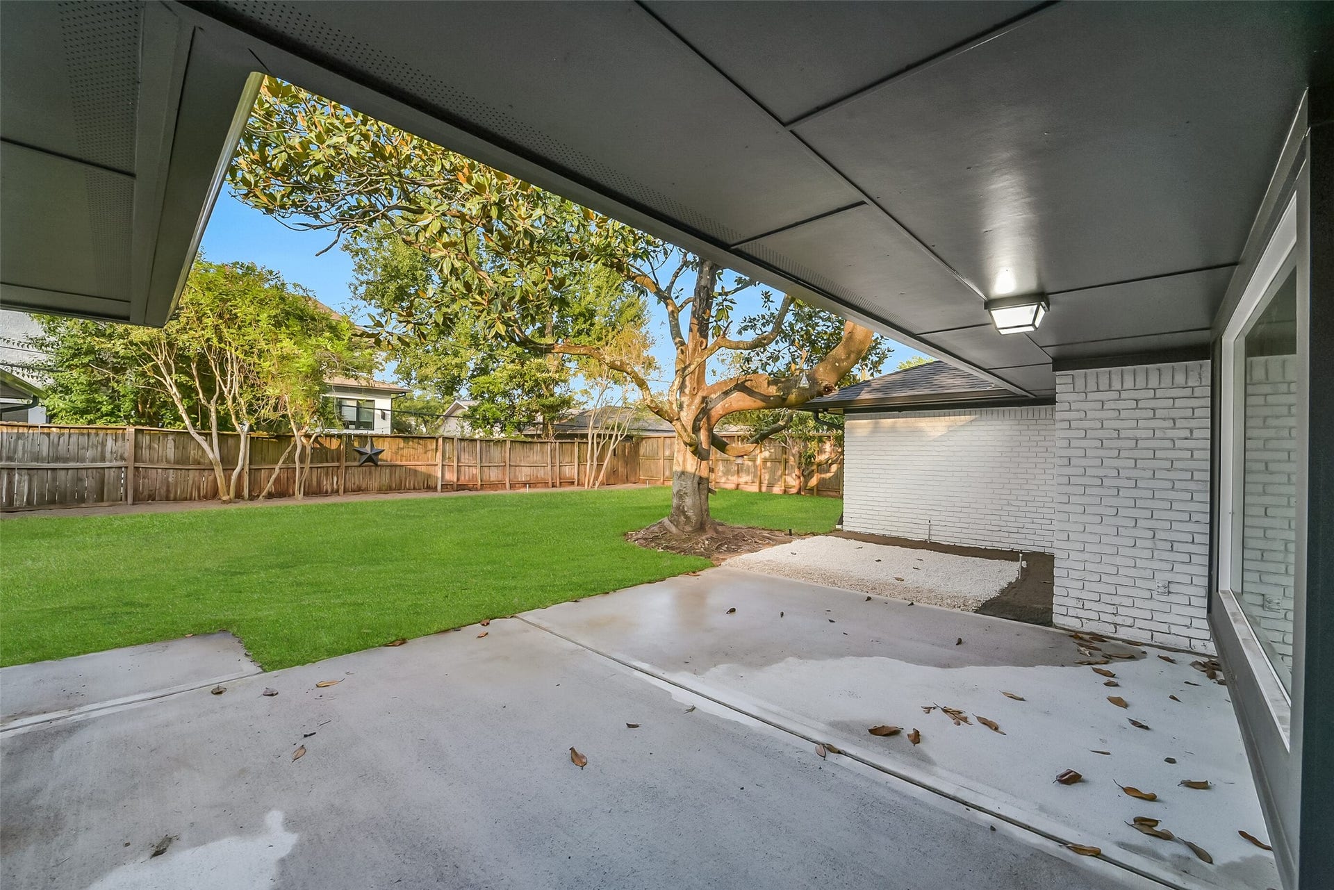 5318 Queensloch Drive, Houston, TX 77096 Partially covered back patio for outdoor dining.