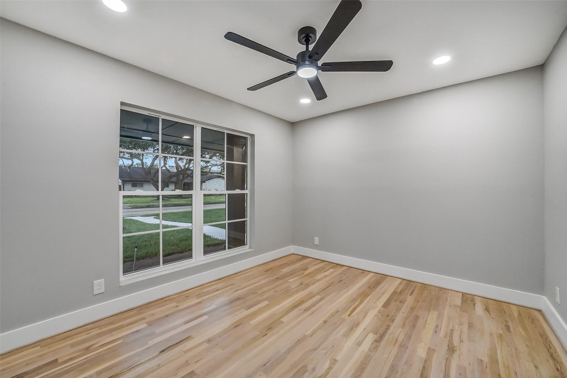 5318 Queensloch Drive, Houston, TX 77096 Secondary bedroom with large picture windows.