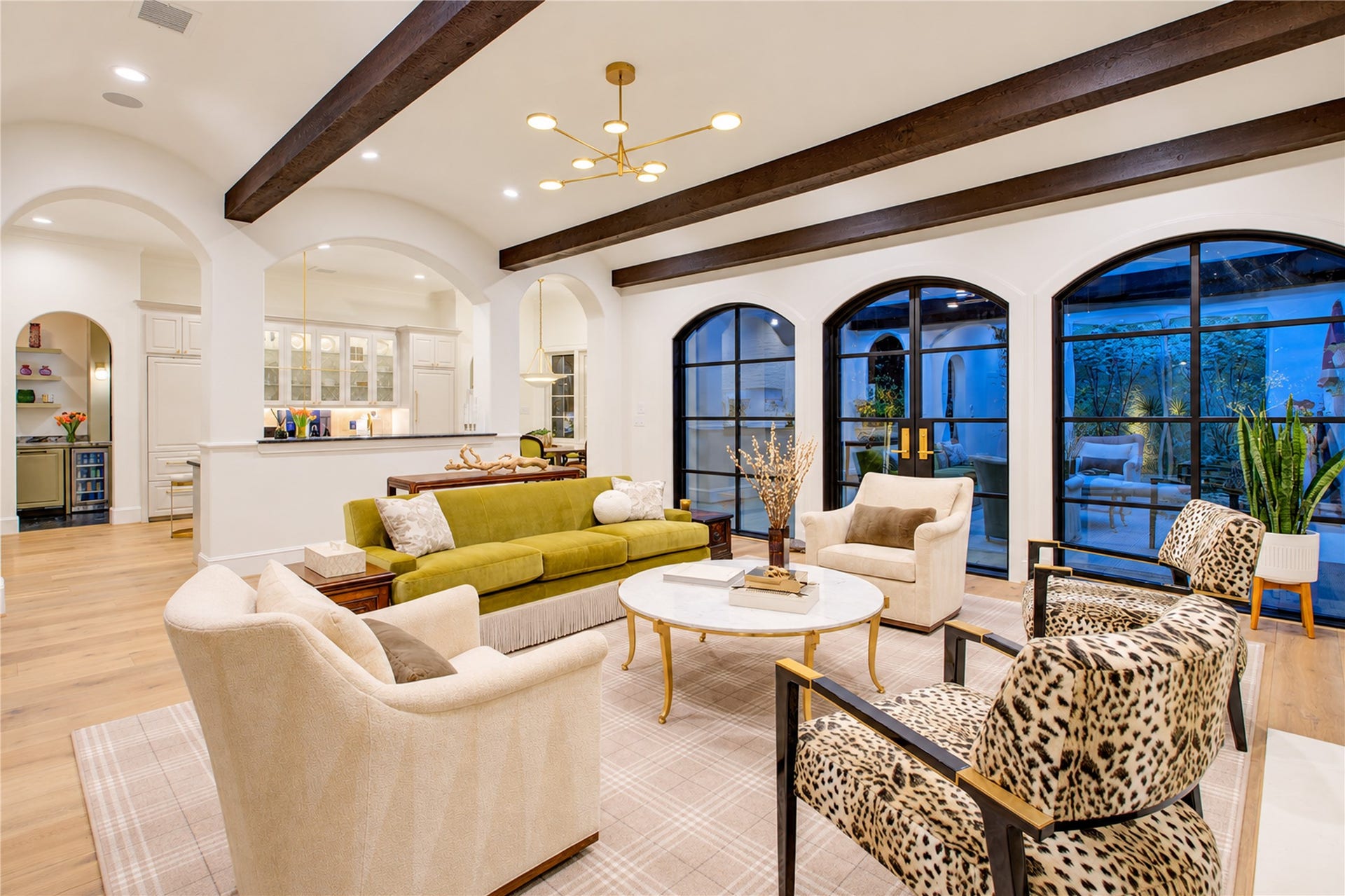 2215 North Boulevard, Houston, TX 77098 Exposed wood beams accentuate the 10-foot triple barrel-vault ceiling, while custom steel doors open to the rear patio and yard.